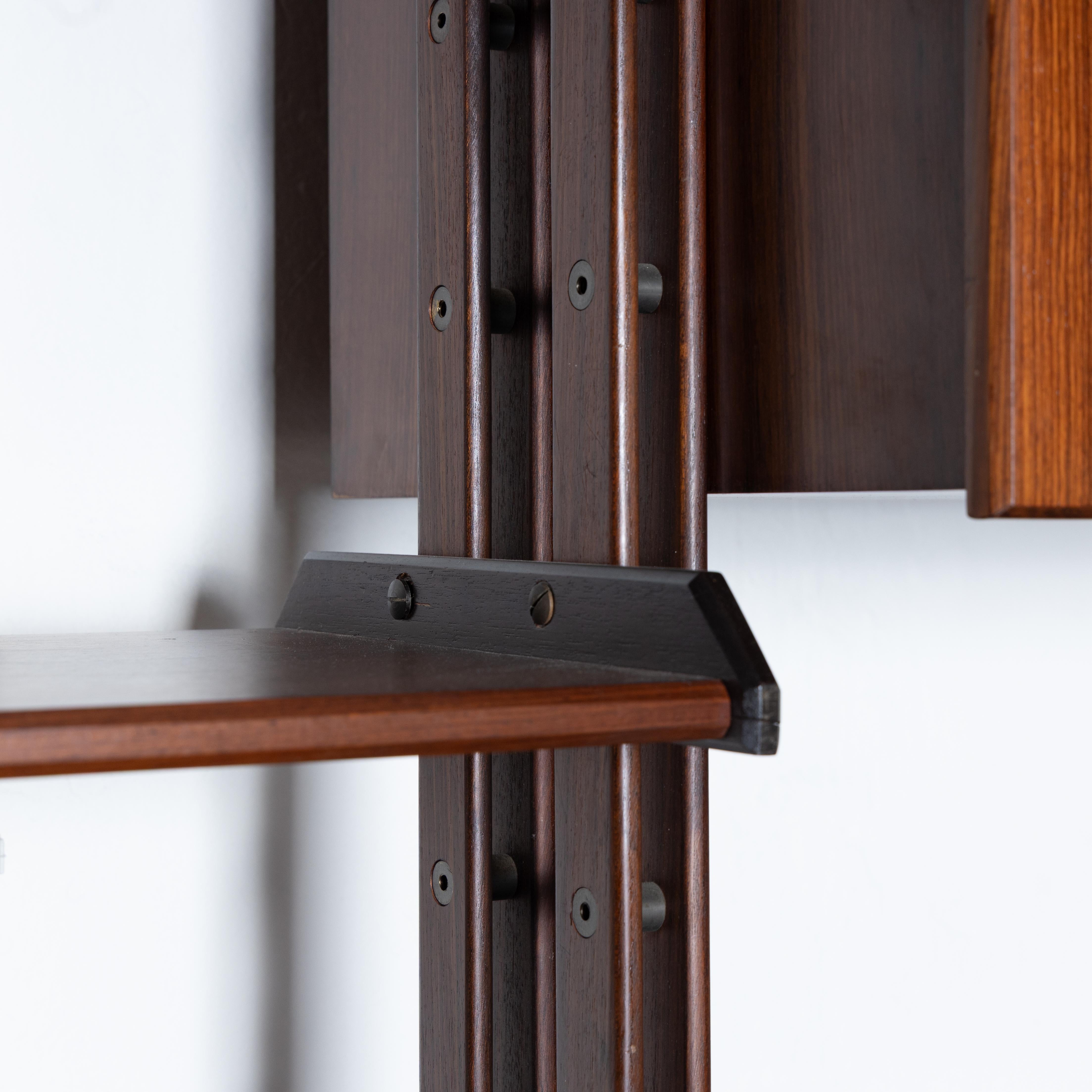 Modular sky-ground bookcase, made of walnut wood, Italian manufacture, inspired by Franco Albini's infinity bookcase, of the highest quality. The bookcase consists of two bays with three storage modules, and shelves. The height is adjustable from