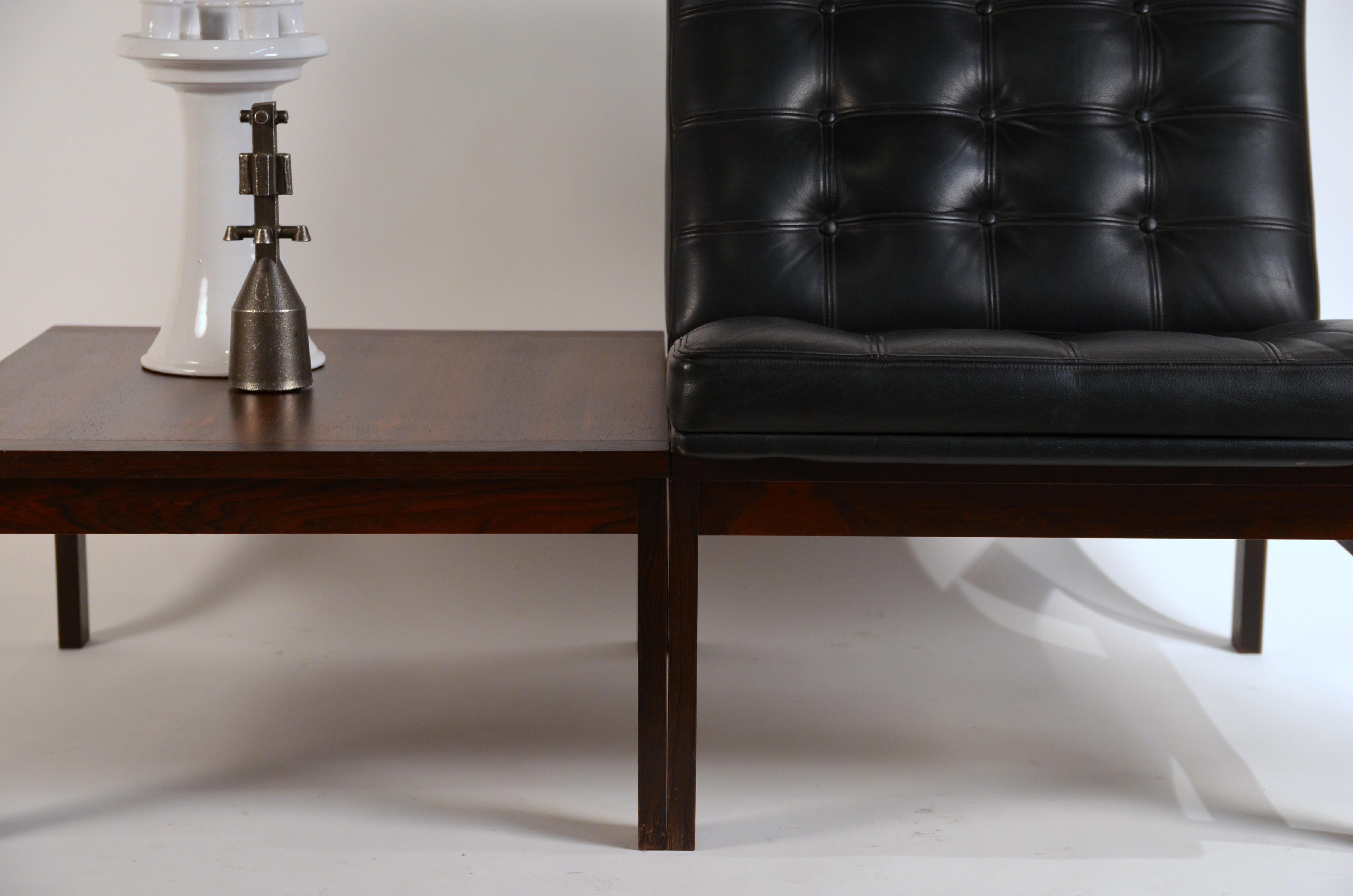 Modular slipper chair and table elements by Ole Gjerløv-Knudsen for France & Søn. Fine grain tufted black leather seat and back and beautiful rosewood top over solid rosewood frames. Original France & Søn tags under the seat and the table top. Made