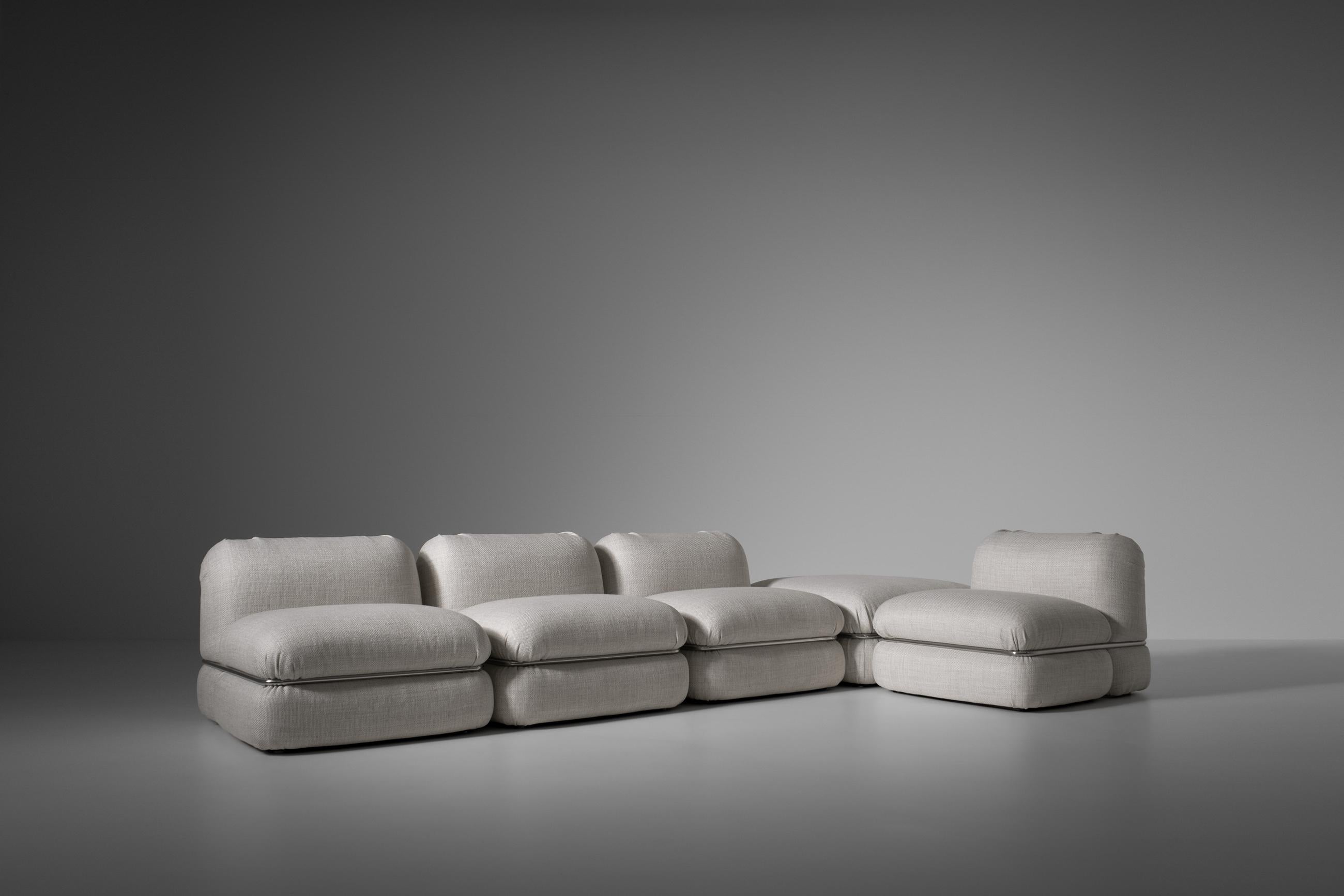 Modular sofa by Rodolfo Bonetto for Tecnosalotto, Italy 1960s. Very comfortable sofa consisting out of four square modular elements and a pouf. The cushions are held together by chromed metal clamps. The sofa is reupholstered in an off white / beige