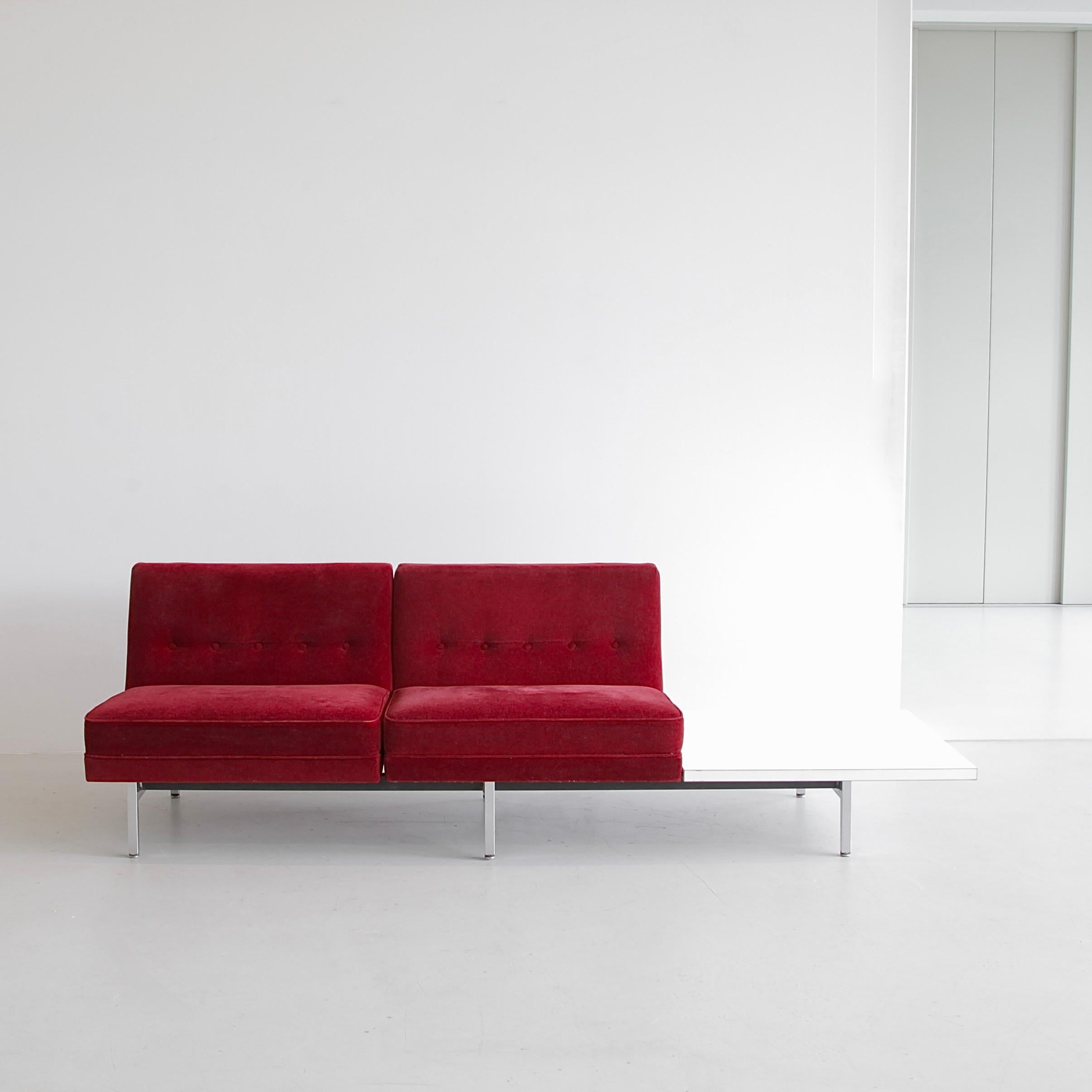 Two-seat Sofa designed by George Nelson. U.S.A., Herman Miller, 1960s.

Modular Sofa by George Nelson with a strong metal structure including chrome-plated feet. Two vintage red Mohair upholstered Seats with buttoned backrests and a square Formica