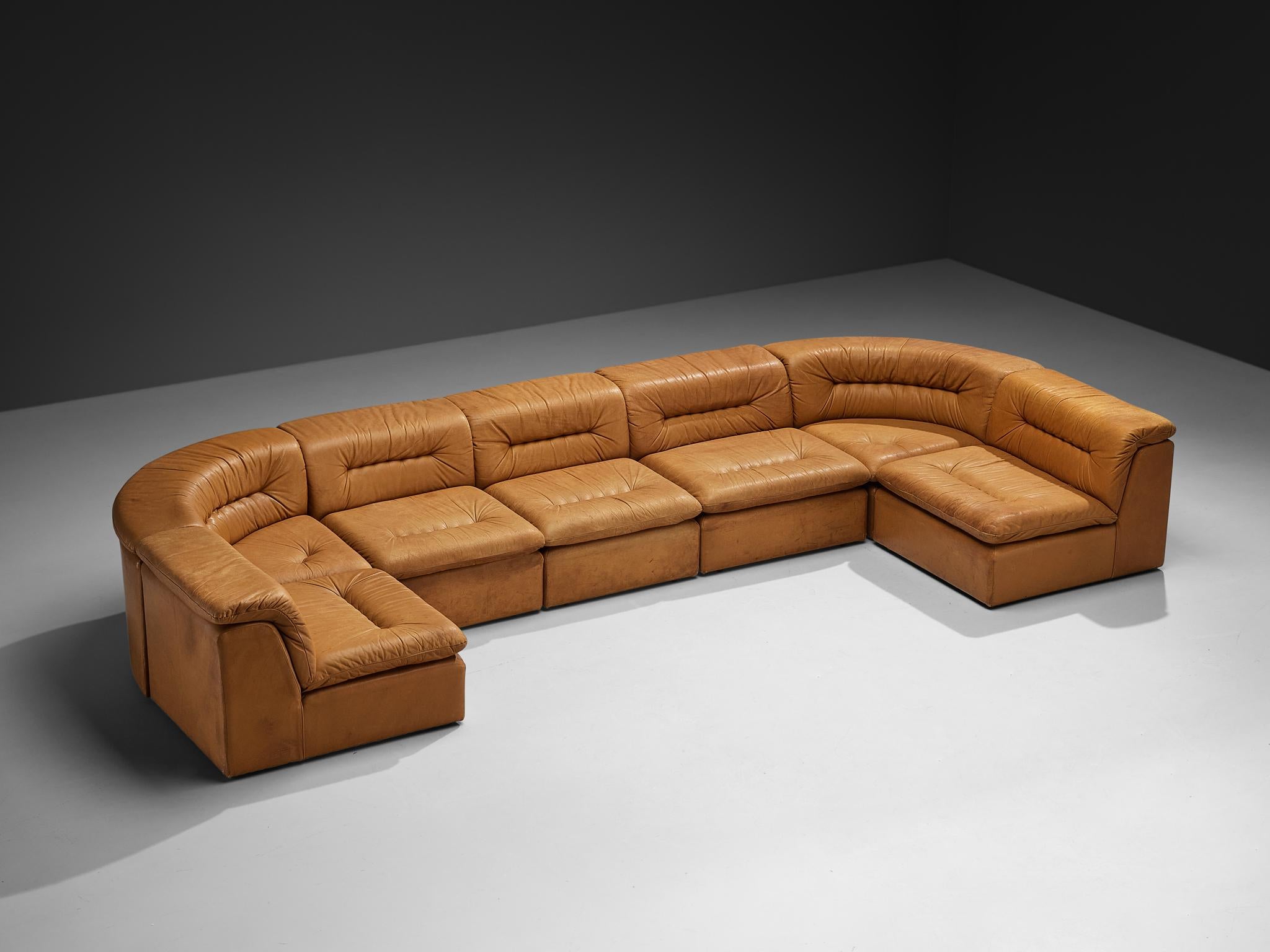 Modular sofa, leather, Europe, 1970s

This attractive modular sofa, crafted in Europe during the 1970s, displays an obvious postmodern charm. Upholstered in patinated cognac leather, it offers warmth and character. The modular design of these eight