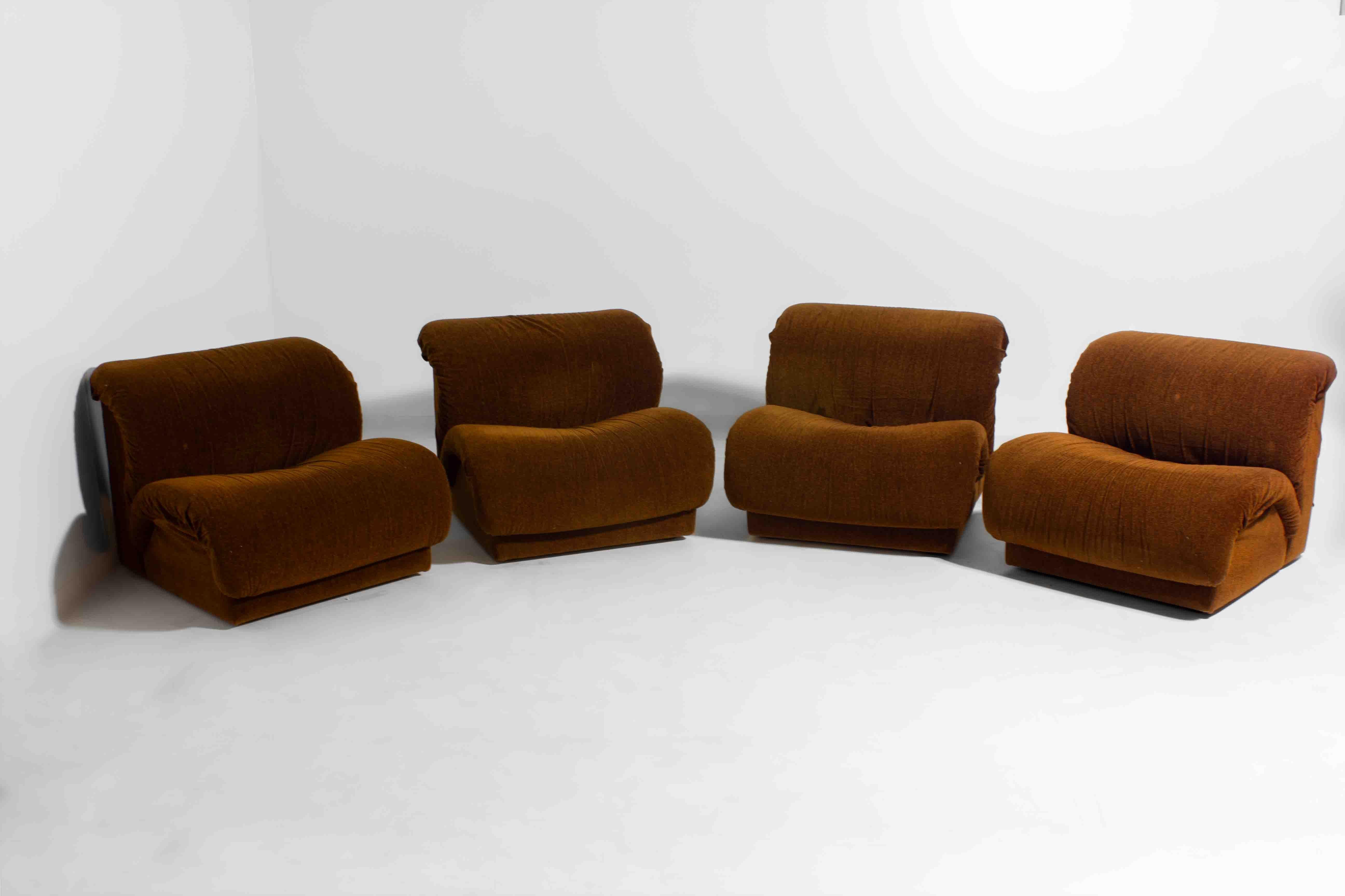 Modular seating system by Italian manufacturer Doimo, produced in the 1970s. This set consists of four identical armless elements that can be used separately as lounge chairs or combined into a larger sofa. The soft, sculpted forms are upholstered