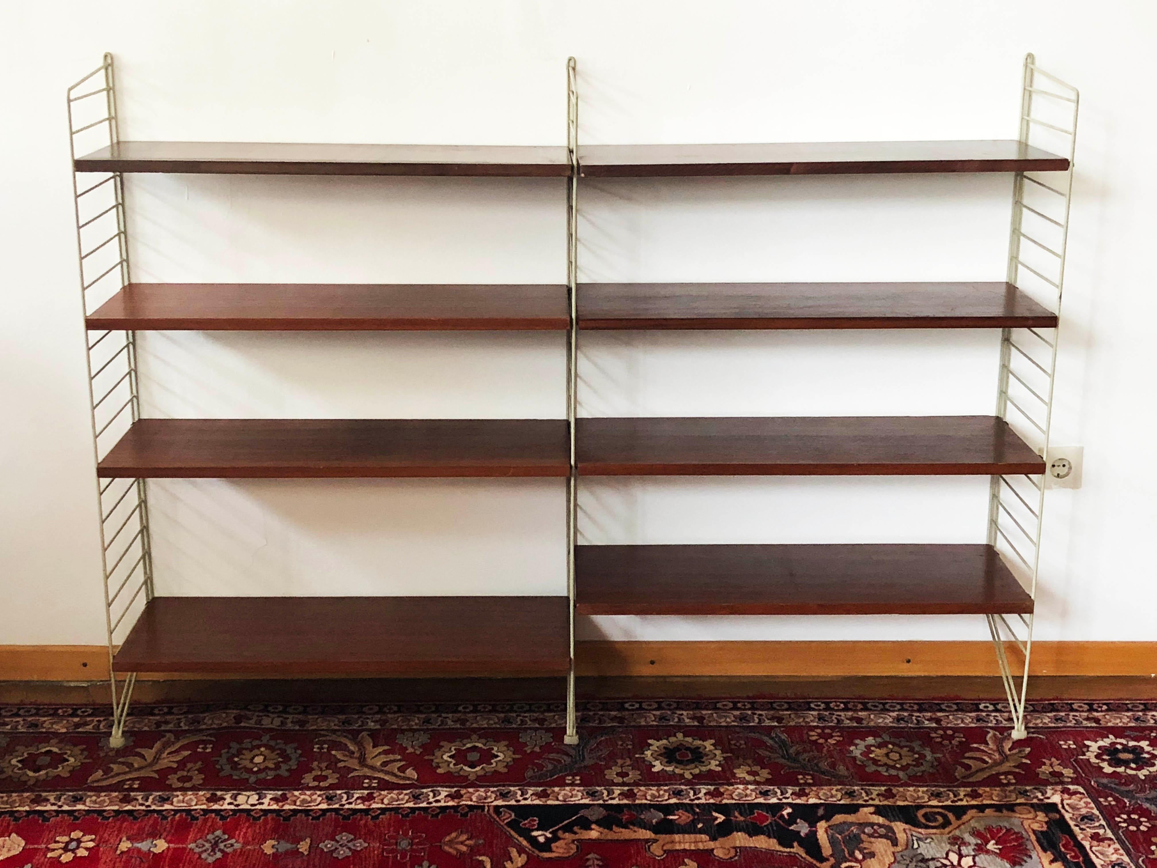 String regal wall unit designed by Nils and Kajsa Strinning in 1949. This one was made in the 1960s in Sweden.
A very good vintage condition, slight traces of use due to the age, nice patina.
Measures: Height 117cm and width of 160 cm.
Eight