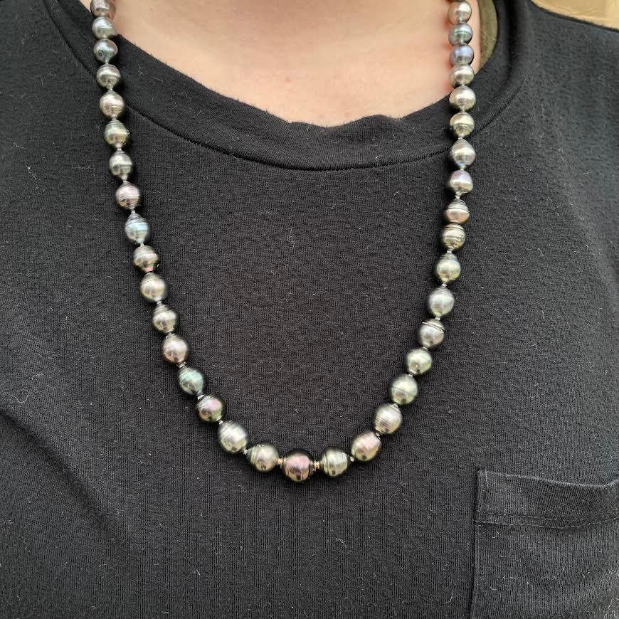 A 25 inch long knotted strand of 8 x 10mm Tahitian pearls strand with 18k rose gold 
