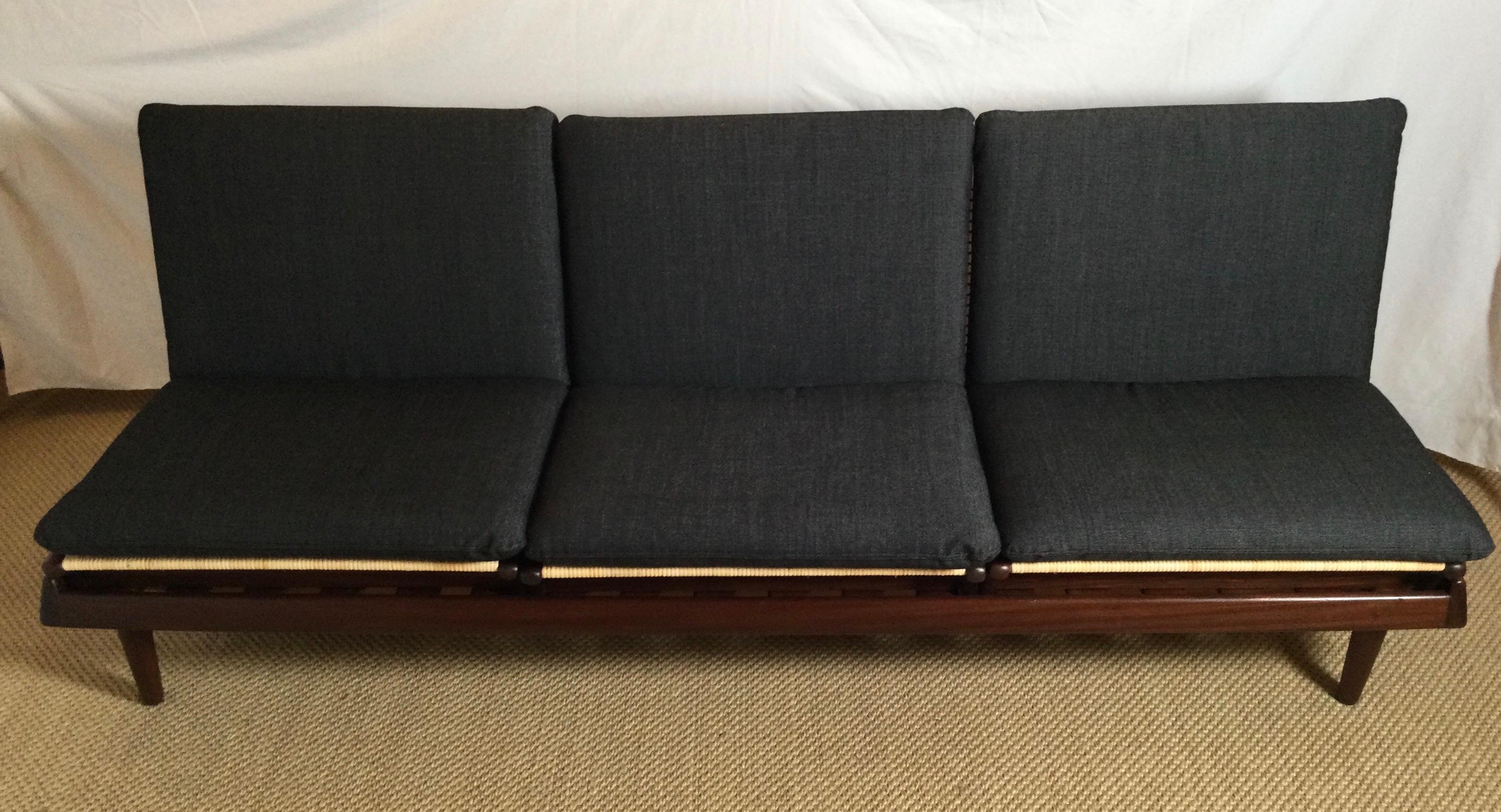 An extraordinary early example of a TV modular sofa designed by Hans Olsen and manufactured by Bramin of Denmark. This modular sofa consists of one bench with three seats. The bench can be used as a daybed or the elevated framework for the three