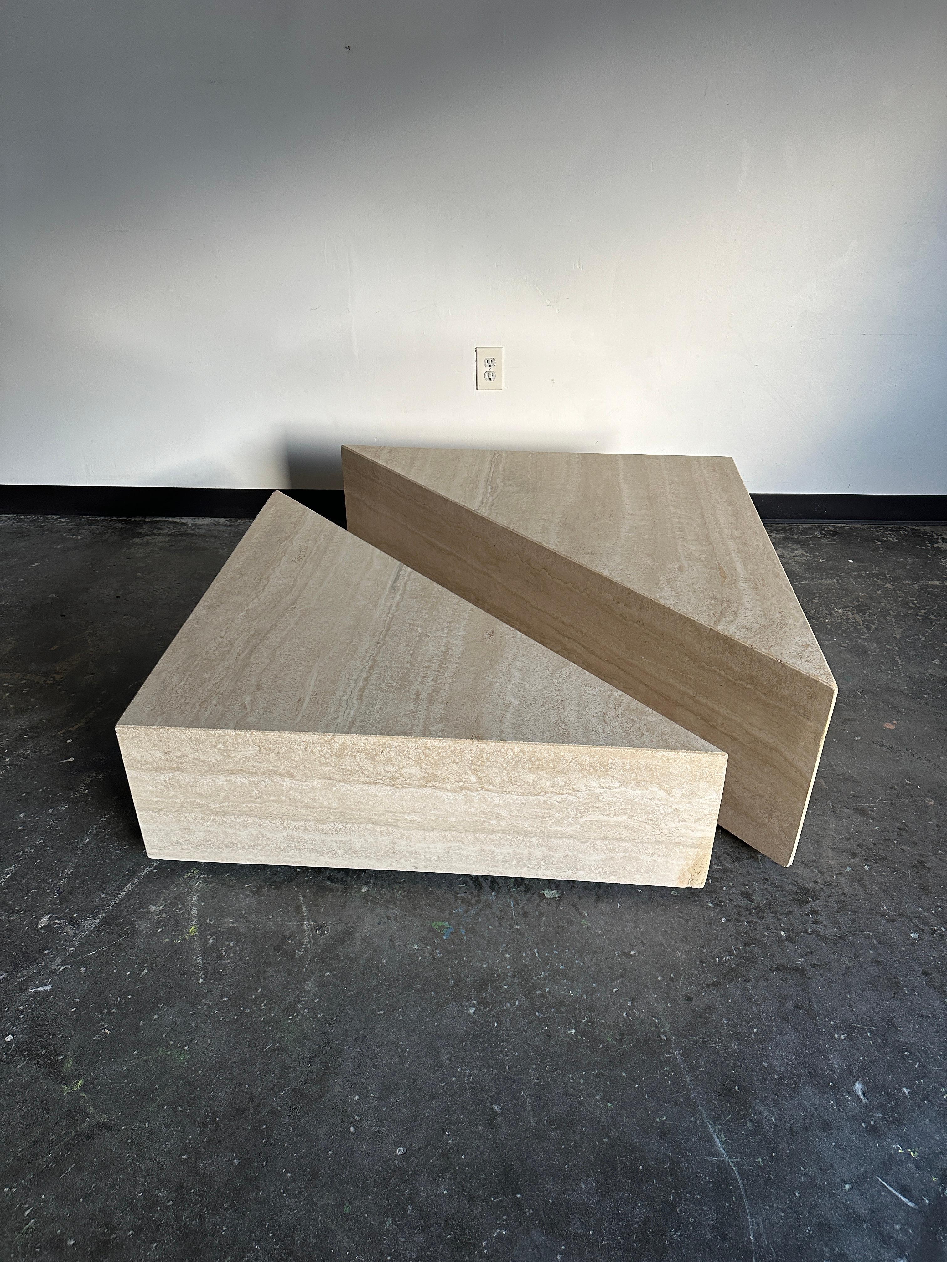 Travertine center/coffee table consisting of two right triangles finished on three sides. bottom is hollow with casters for easy moving. Because all sides are finished, pieces can be situated in a variety of configurations- including independent of