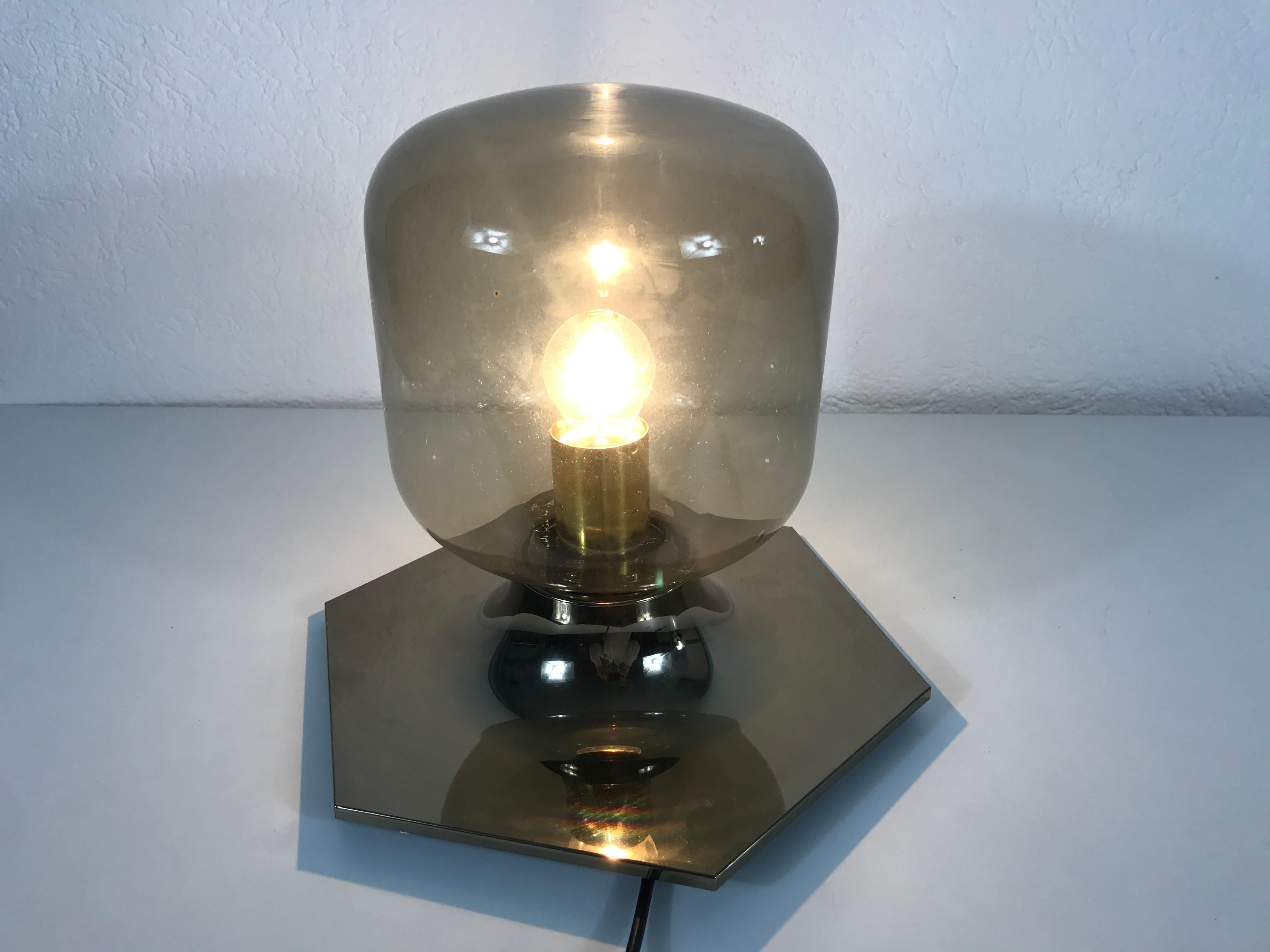 Wall or ceiling light by the Japanese designer Motoko Ishii for the German brand Staff Leuchten. It has a very thin amber glass shade and a brass base.

The lights require one E27 light bulb.