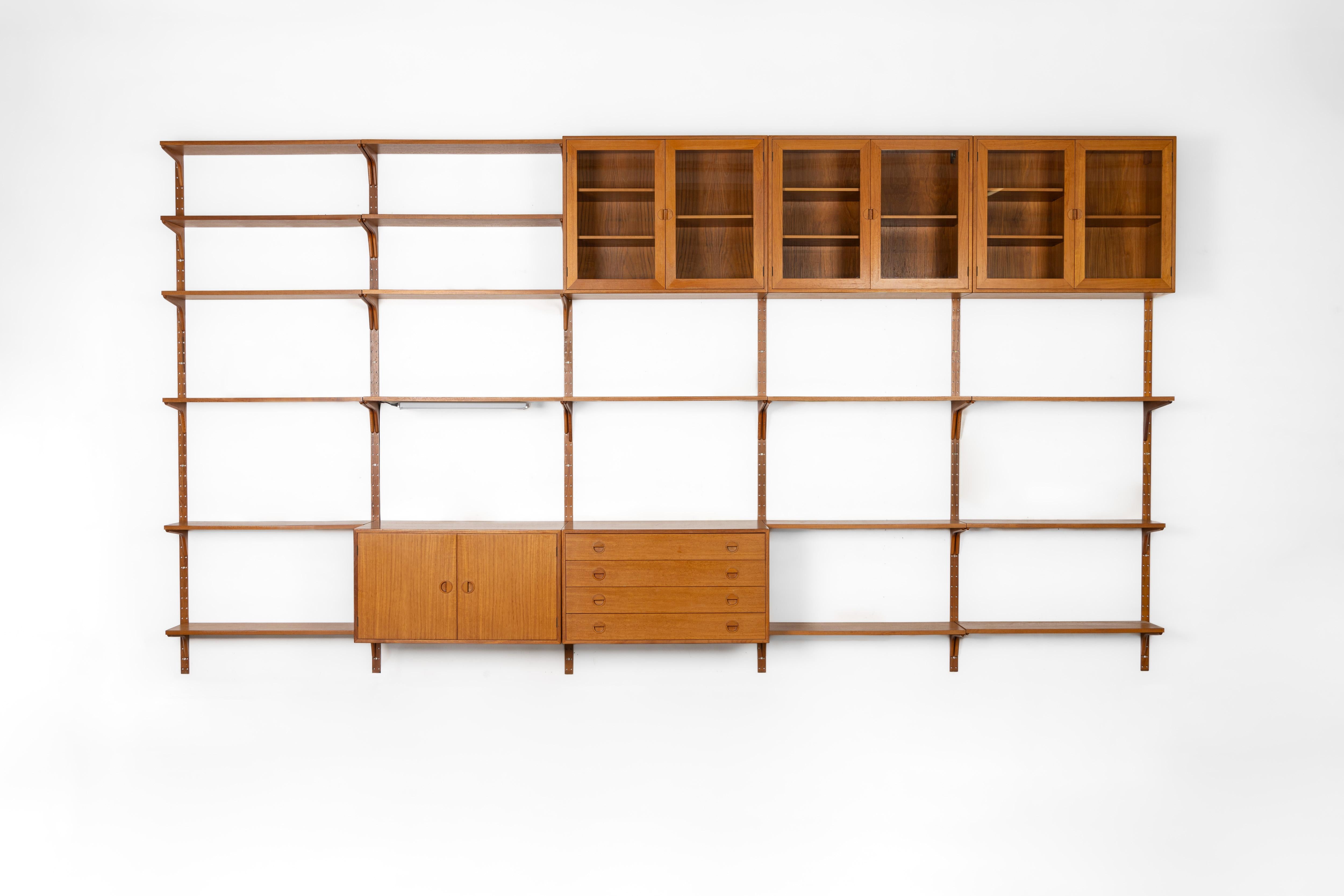 Danish modular wall unit by Rud Thygesen for HG Furtniture. This teak setup has one drawer cabinet, one storage cabinet, three display cabinets and 17 bookshelves. The cabinets are marked by the producer. Always adaptable and further