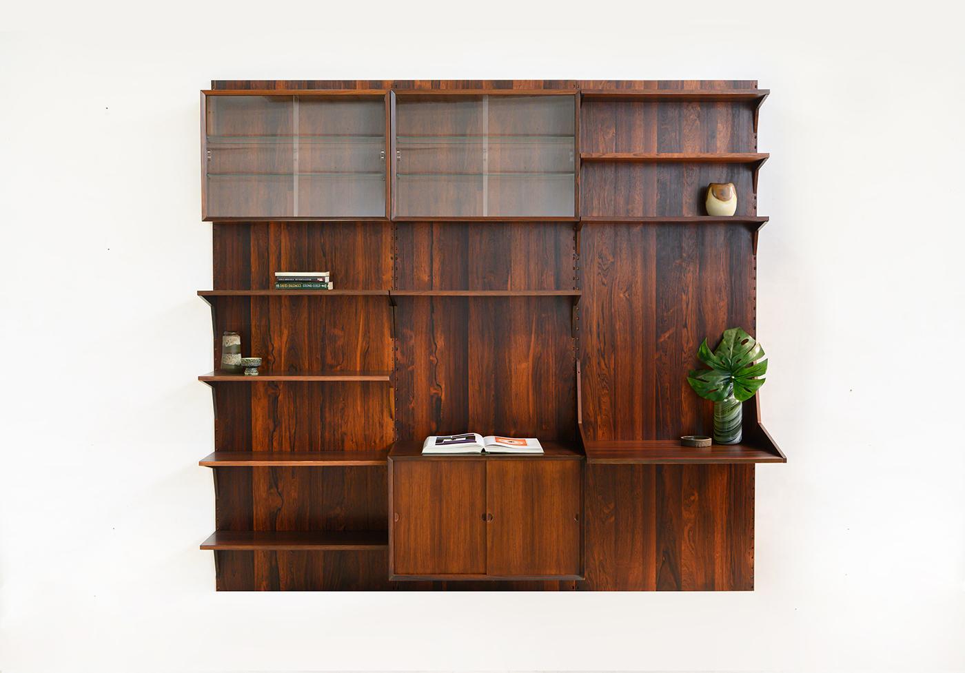 Danish modular wall unit by Poul Cadovius for Cado, Denmark 1960s. This rosewood setup has one storage cabinet, two display cabinets, one desk shelf and eight bookshelves. Always adaptable and further expandable.
