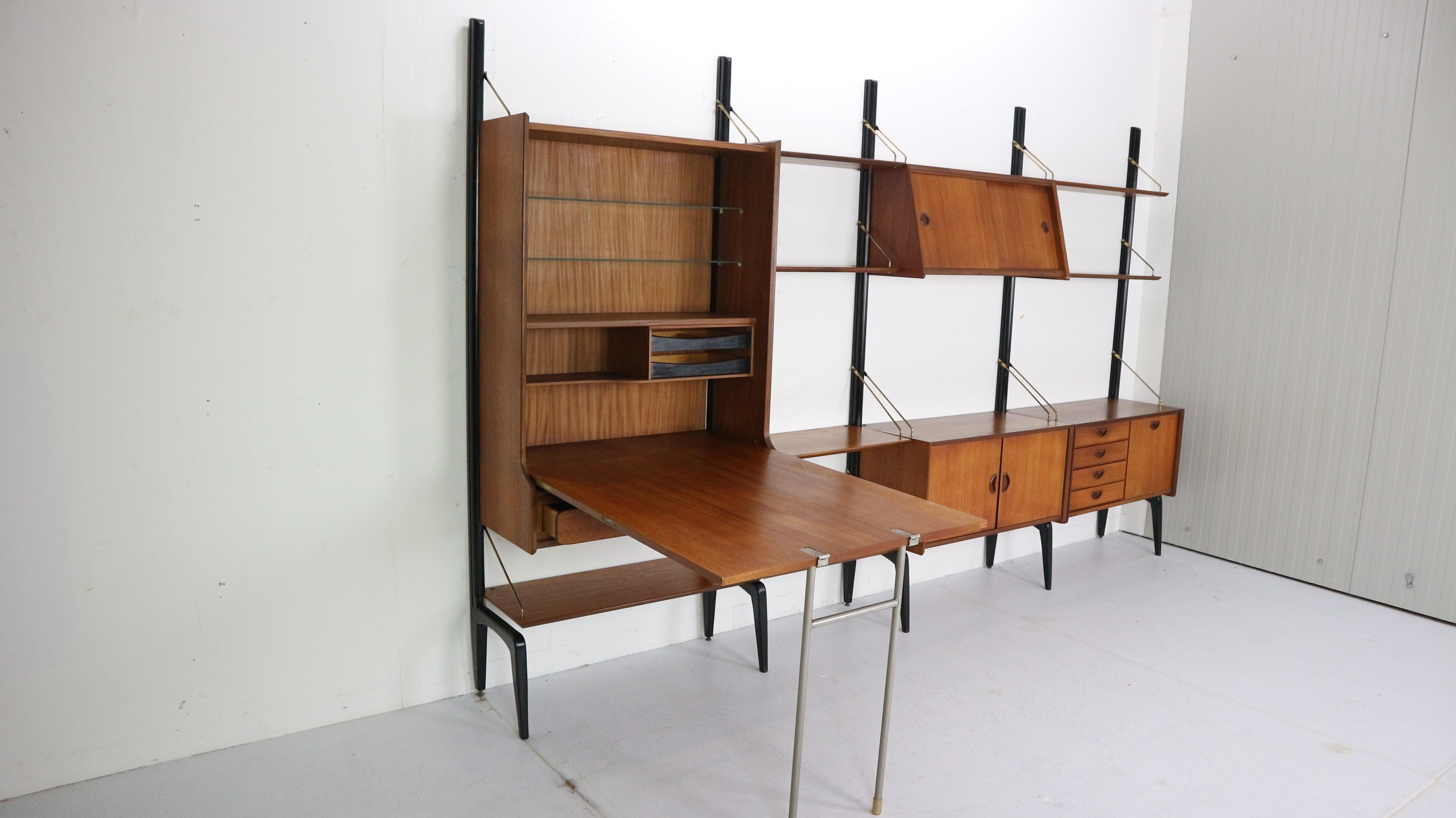 Dutch design modular wall unit by Louis Van Teeffelen for Webe, 1950s. One of Louis Van Teeffelen most famous designs his modular wall system. The combination of its minimalistic lines , warm teak wood, brass rods accents, elegant black wooden