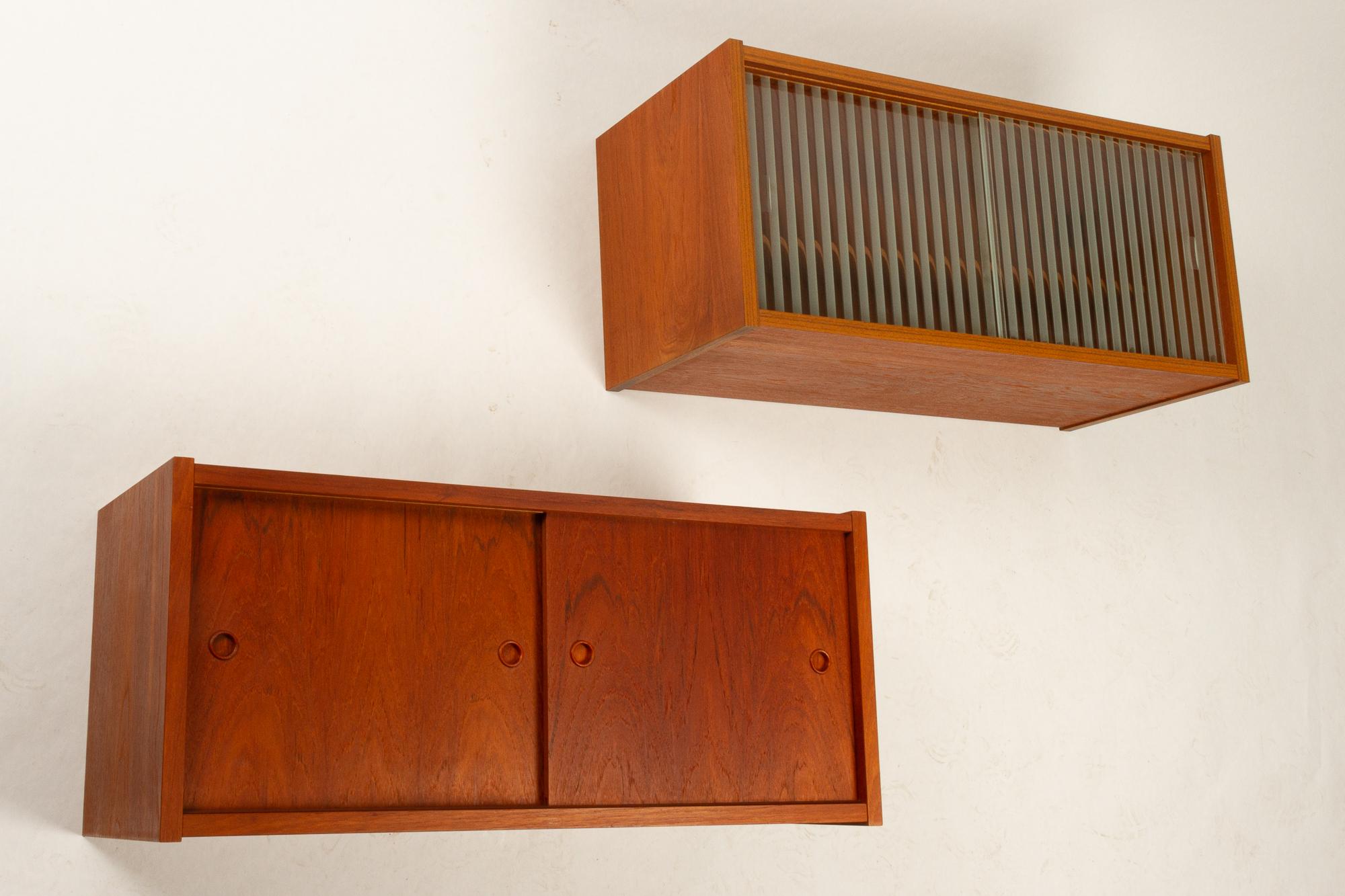 Modular wall units by Preben Sørensen for Randers Møbelfabrik, 1960s.
Set of two modular wall units in teak veneer, known as the PS System.
One unit with double sliding doors in teak with round teak grips. One with double glass sliding doors with