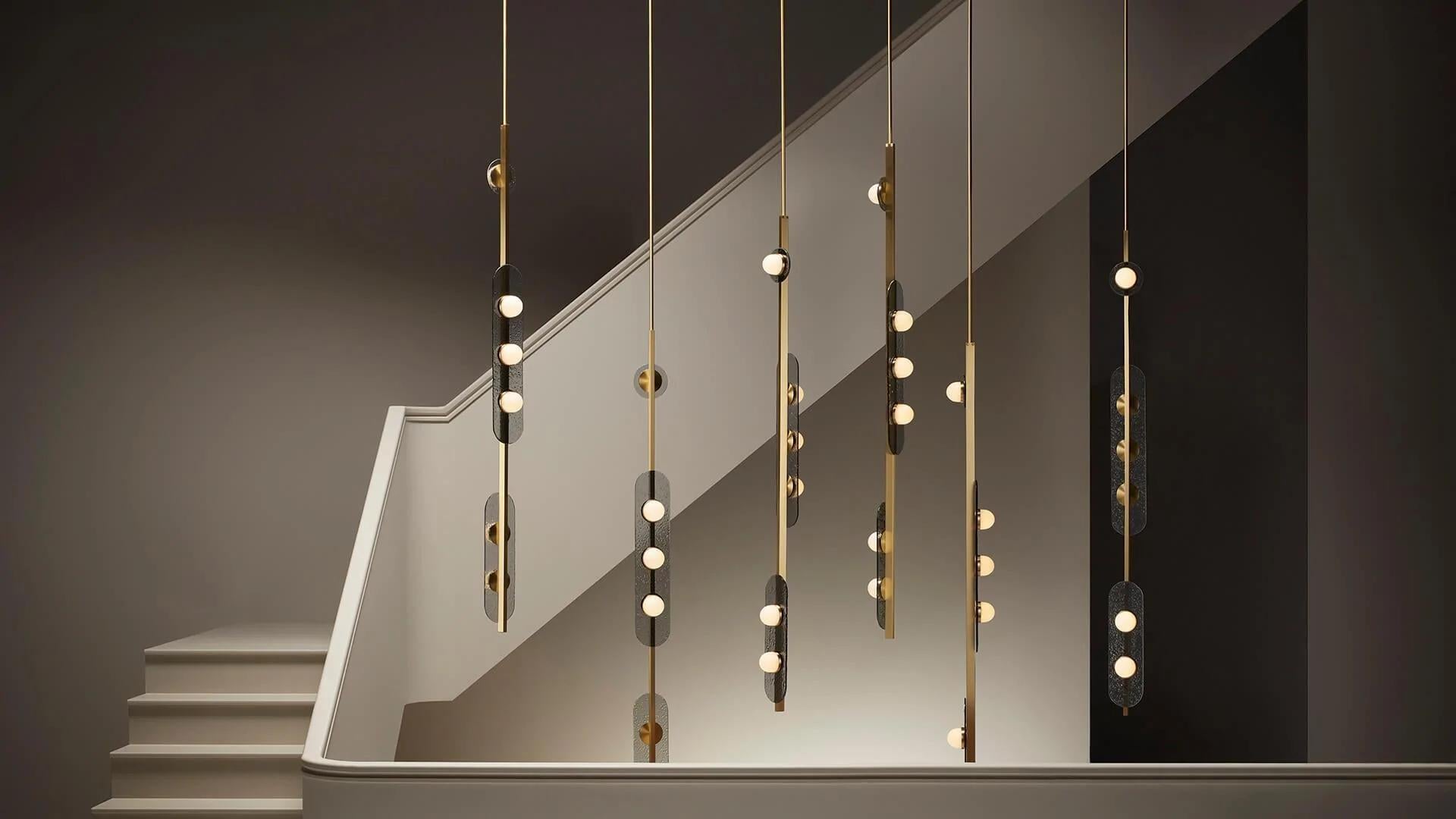 Modulo vertical pendant by CTO Lighting
Materials: Satin brass with smoked kiln cast glass and opal glass shades.
Also available in bronze with smoked kiln cast glass and opal glass shades.
Dimensions: W 12 x D 16 x H 180 cm

All our lamps can