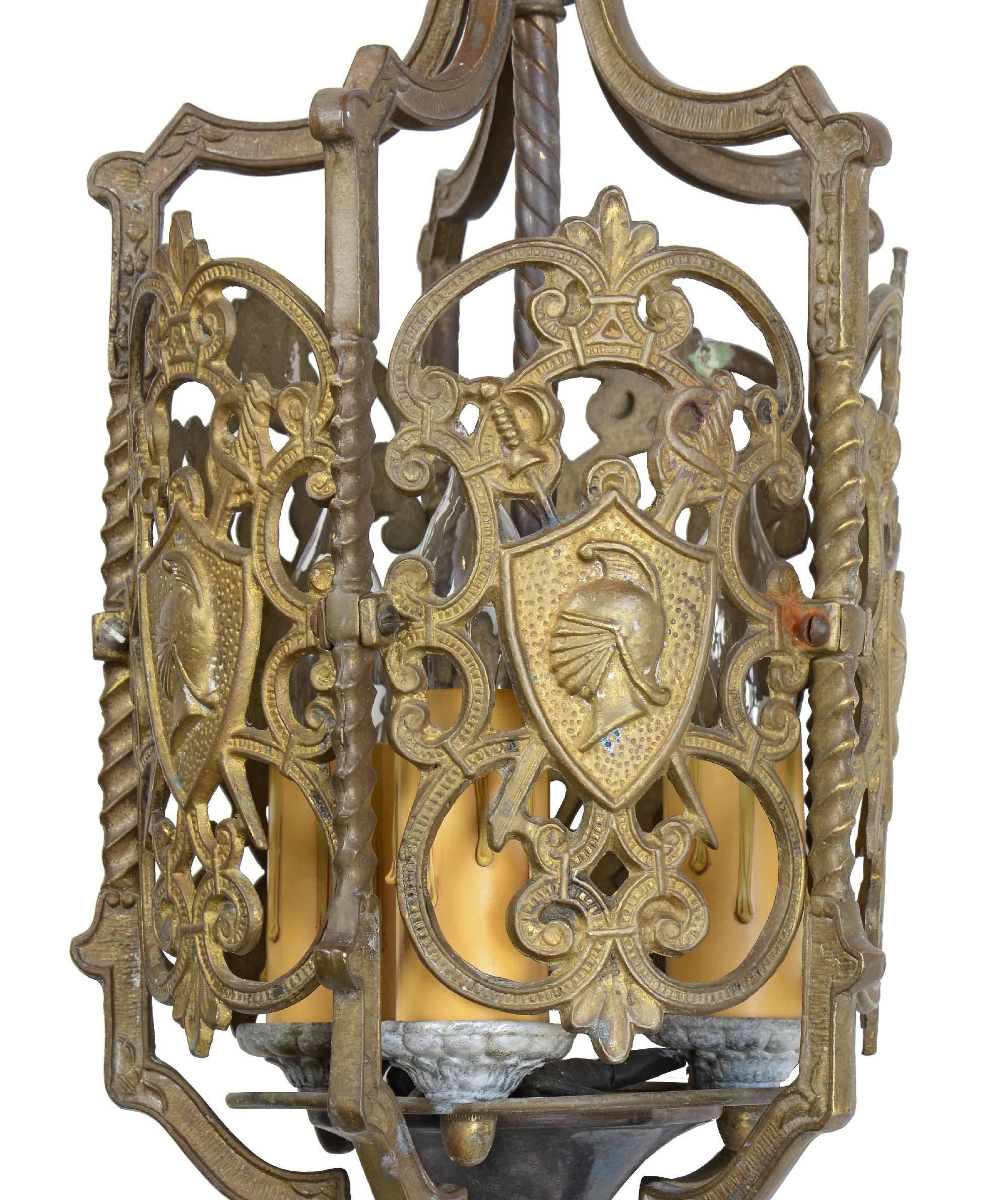 This decorative brass pendant by Moe Bridges features scrolling details, swords and shield with helmet cameo, twisted rods, anthemion’s, and dragon heads.

Brothers Henrik and Ole Moe founded the Moe Bridges Company in 1919 in Milwaukee, WI, where