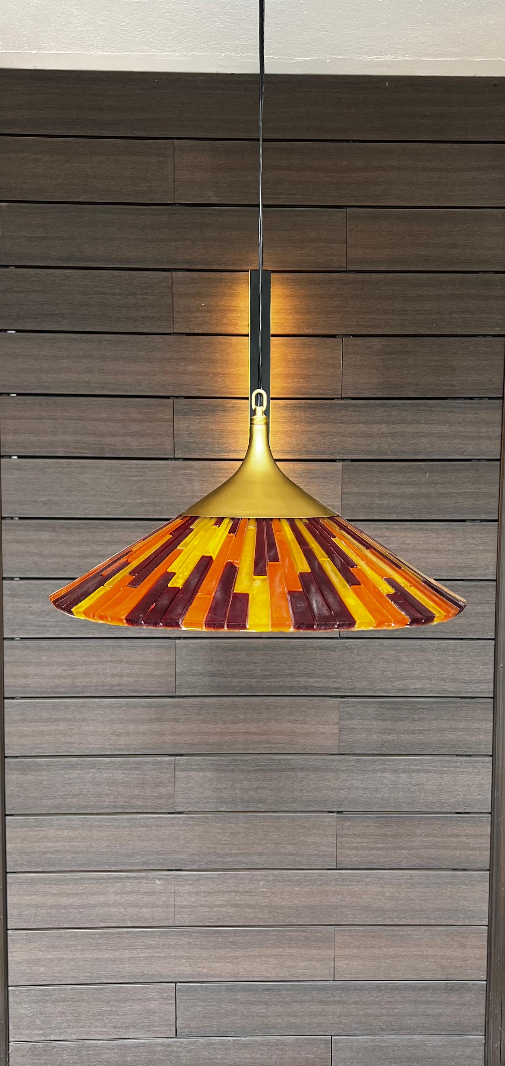 Colorful mod ceiling lamp by Moe Lighting. Acrylic bars of red, orange and yellow are fused together. It is missing the plastic cover that goes along the bottom, new cable and socket. Works perfectly
