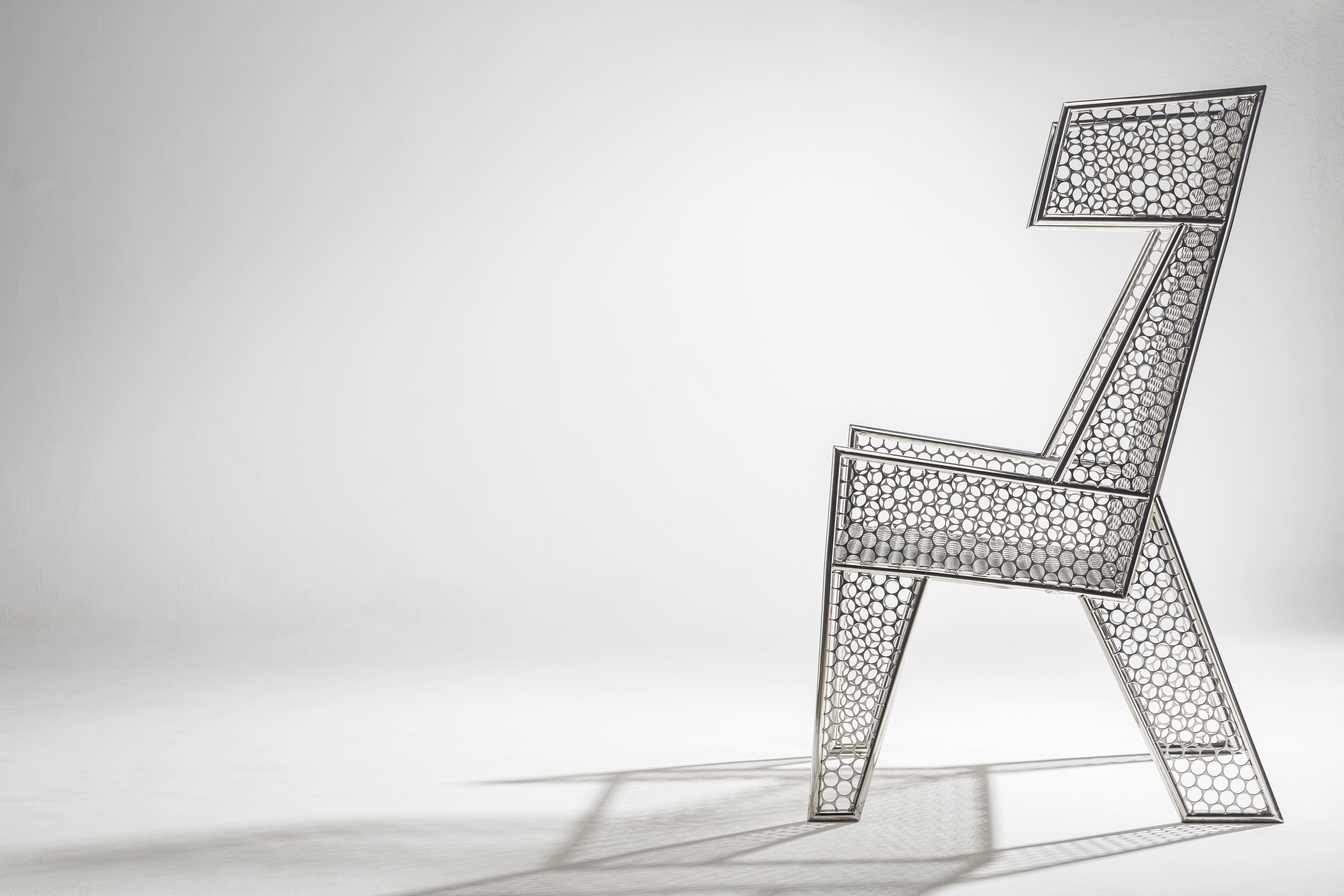 The Moeda Bergère Armchair features an elegant and modern design, crafted with precision from coin blanks sourced from the Brazilian Mint and stainless steel. The distinctive material gives the chair a unique, industrial charm while adding a touch