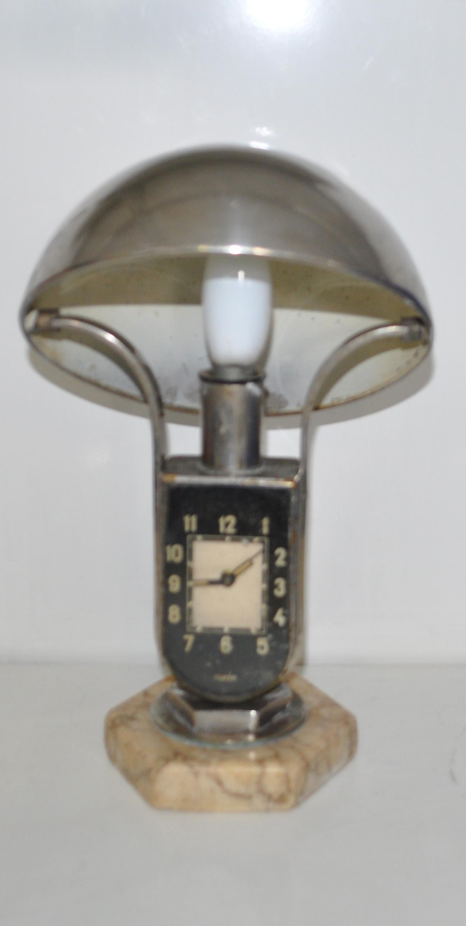 Mofem, Art Deco lamp with alarm clock.
Hungarian 1930s side lamp with integrated alarm clock. Made of nickel-plated metal, has a nice marble base and an adjustable hemispheric lampshade. Fully working. In good condition, with patina on the