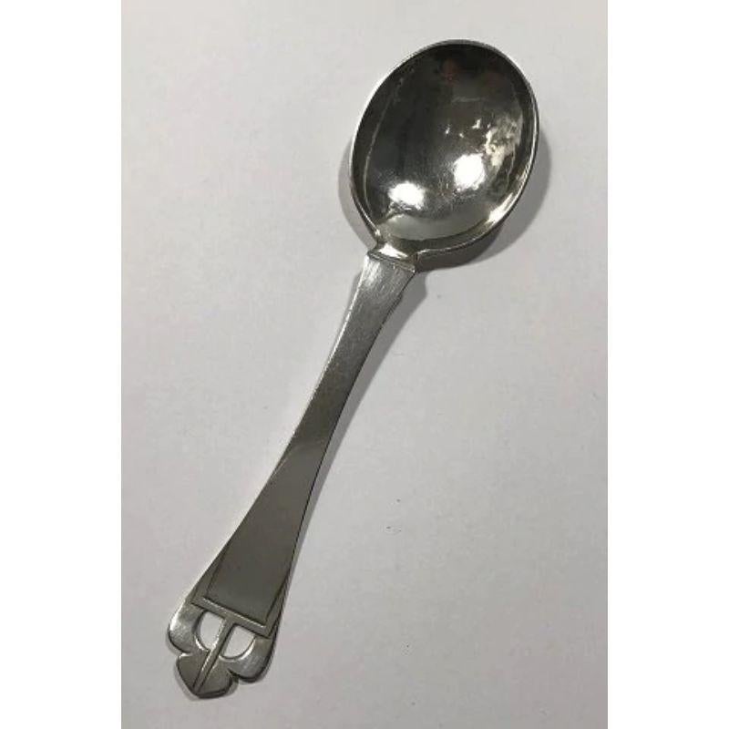 Mogens Ballin 826 Danish silver serving spoon (Engraved)

Measures 19 cm (7½ in).