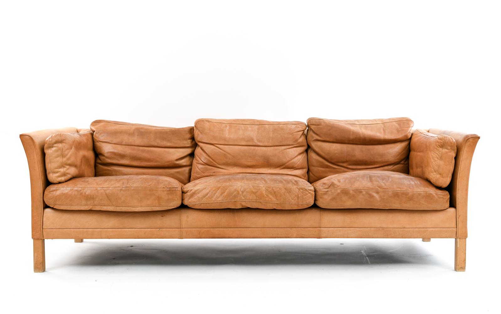 Lovely and comfortably worn thick leather sofa by Mogens Hansen.