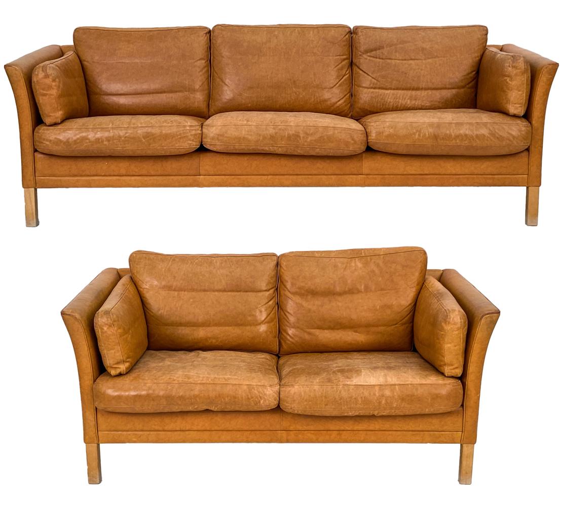 A gorgeous Danish modern seating suite including a three-seater sofa and two-seater loveseat, in handsomely patinated brandy leather. By Mogens Hansen, one of Denmark's leading 20th century manufacturers of leather seating, these sofas are in the