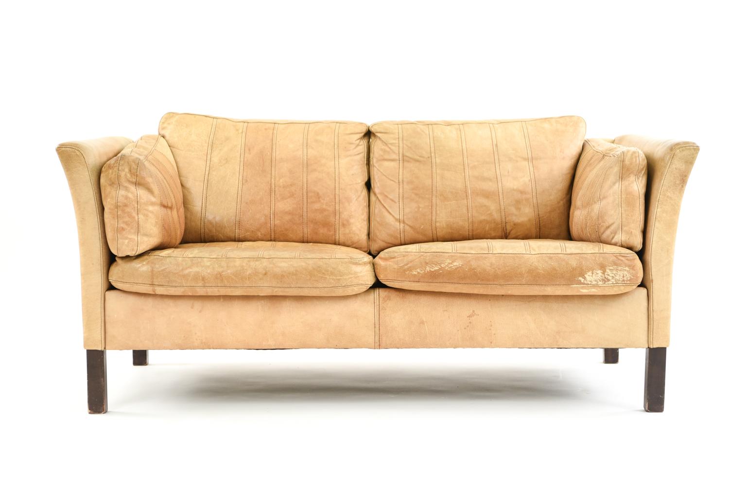 This beautiful Mogens Hansen sofa suite in supple butterscotch leather is the perfect way to create a cohesive interior space with matching seating. The seams on the leather create a visually interesting texture.