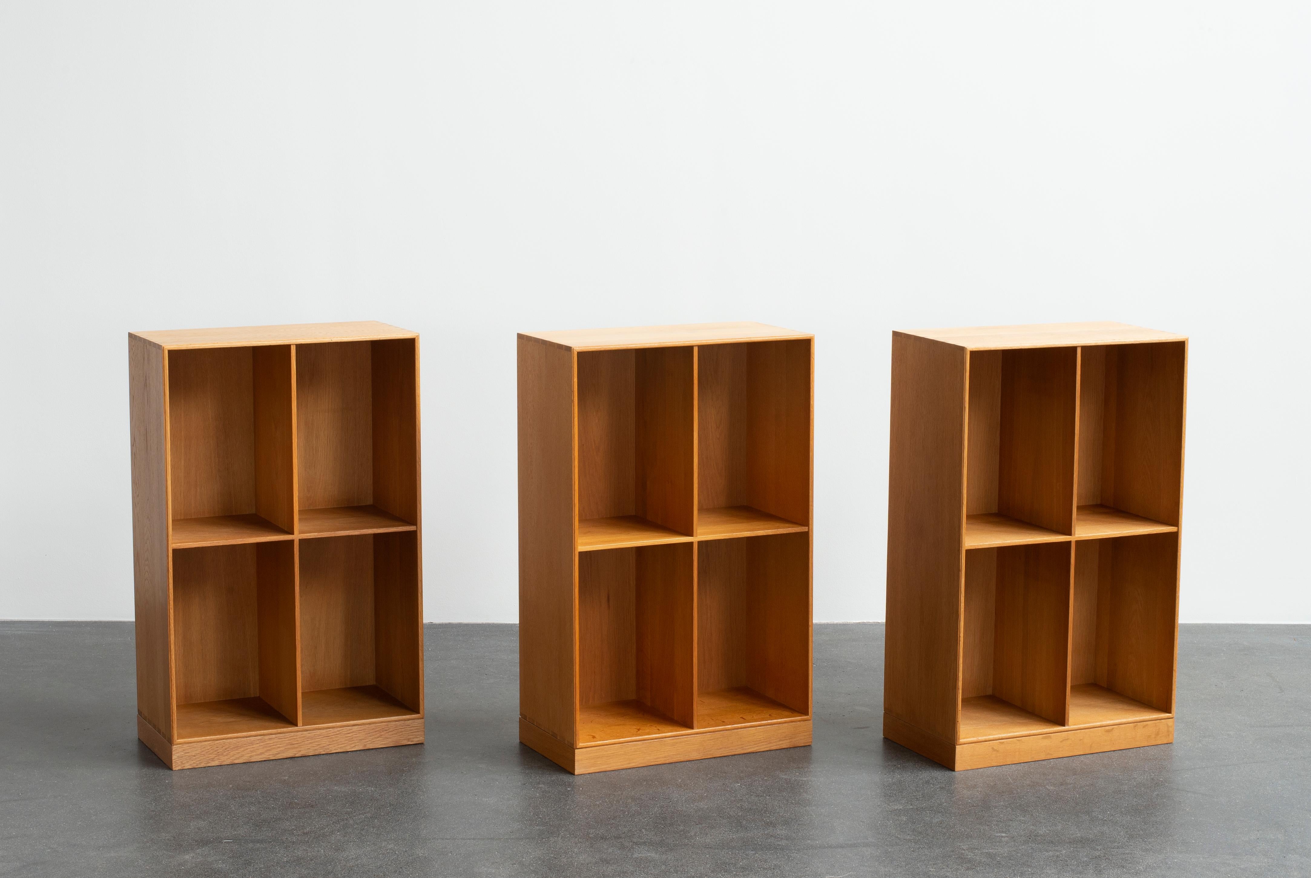 Mogens Koch three bookcases with plinths in oak. Executed by Rud Rasmussen.

Reverse with paper labels ‘RUD. RASMUSSENS/SNEDKERIER/KØBENHAVN/DENMARK.