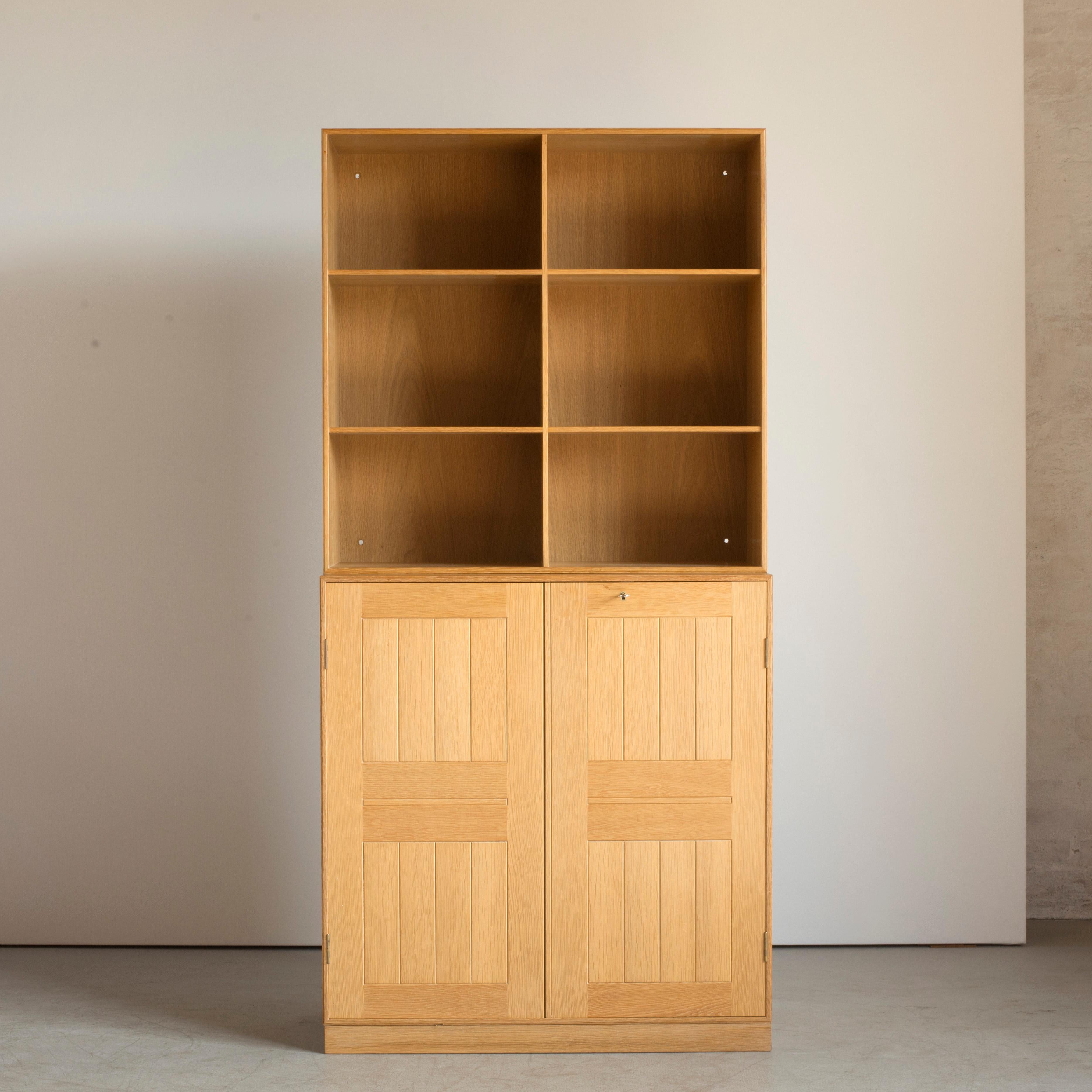 Mogens Koch cabinet with plinth and a wall-mounted bookcase. Executed by Rud. Rasmussen.

Reverse with paper labels ‘RUD. RASMUSSENS/SNEDKERIER/COPENHAGEN/DENMARK.