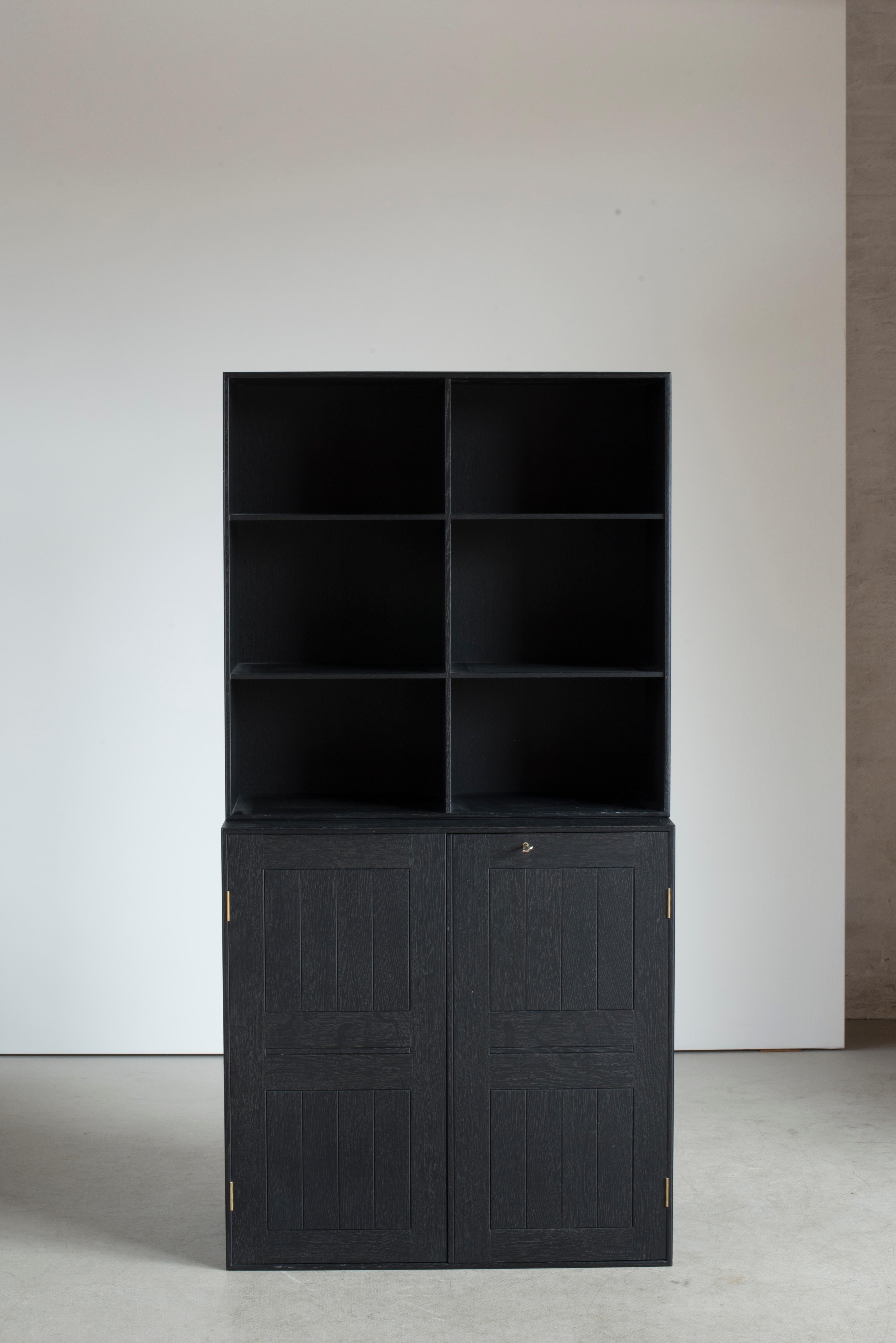 Mogens Koch cabinet and a bookcase in black stained oak. Executed by Rud. Rasmussen.

Reverse with paper labels ‘RUD. RASMUSSENS/SNEDKERIER/COPENHAGEN/DENMARK.