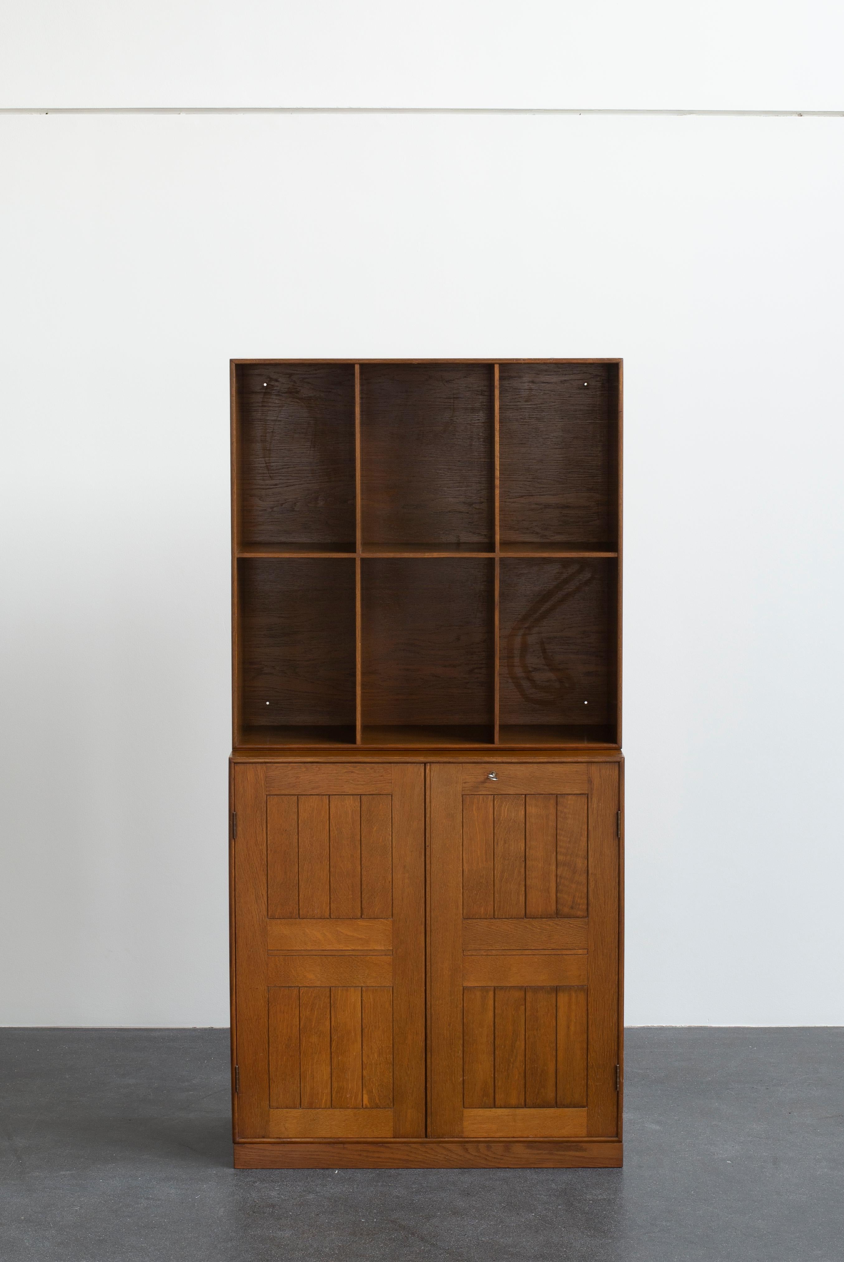 Mogens Koch cabinet and a bookcase in stained oak. Executed by Rud. Rasmussen.

Reverse with paper labels ‘RUD. RASMUSSENS/SNEDKERIER/45 NØRREBROGADE/KØBENHAVN.