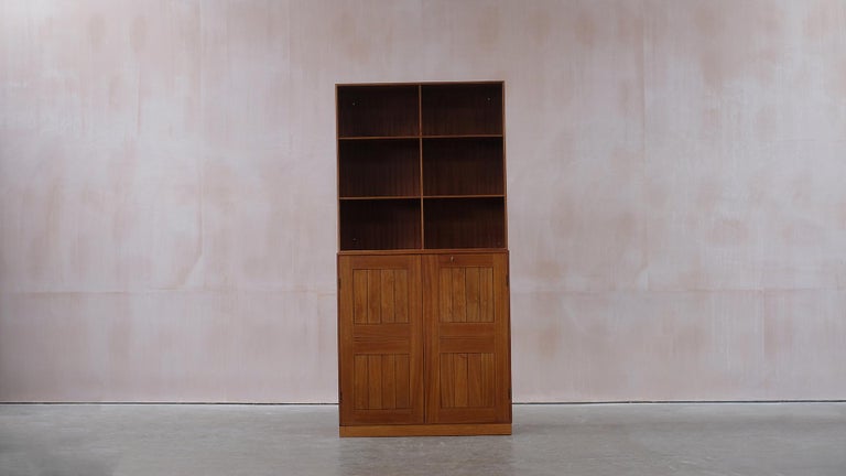 Wonderful cabinet and bookcase with plinth in solid mahogany designed by Mogens Koch for master cabinetmaker Rud Rasmussen, Denmark. This example a rarer model with many internal beech drawers. Classic piece of Danish Design with beautiful details.