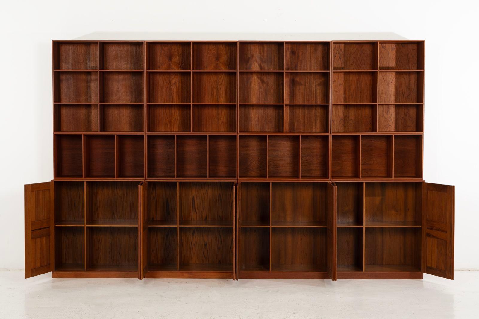 Mogens Koch Cabinets, set of twelve in mahogany for Rud Rasmussen, Denmark, 1960.
A rare and sought-after set crafted in richly toned mahogany wood. Includes eight bookcases—four with six openings each and four half units with three openings each,