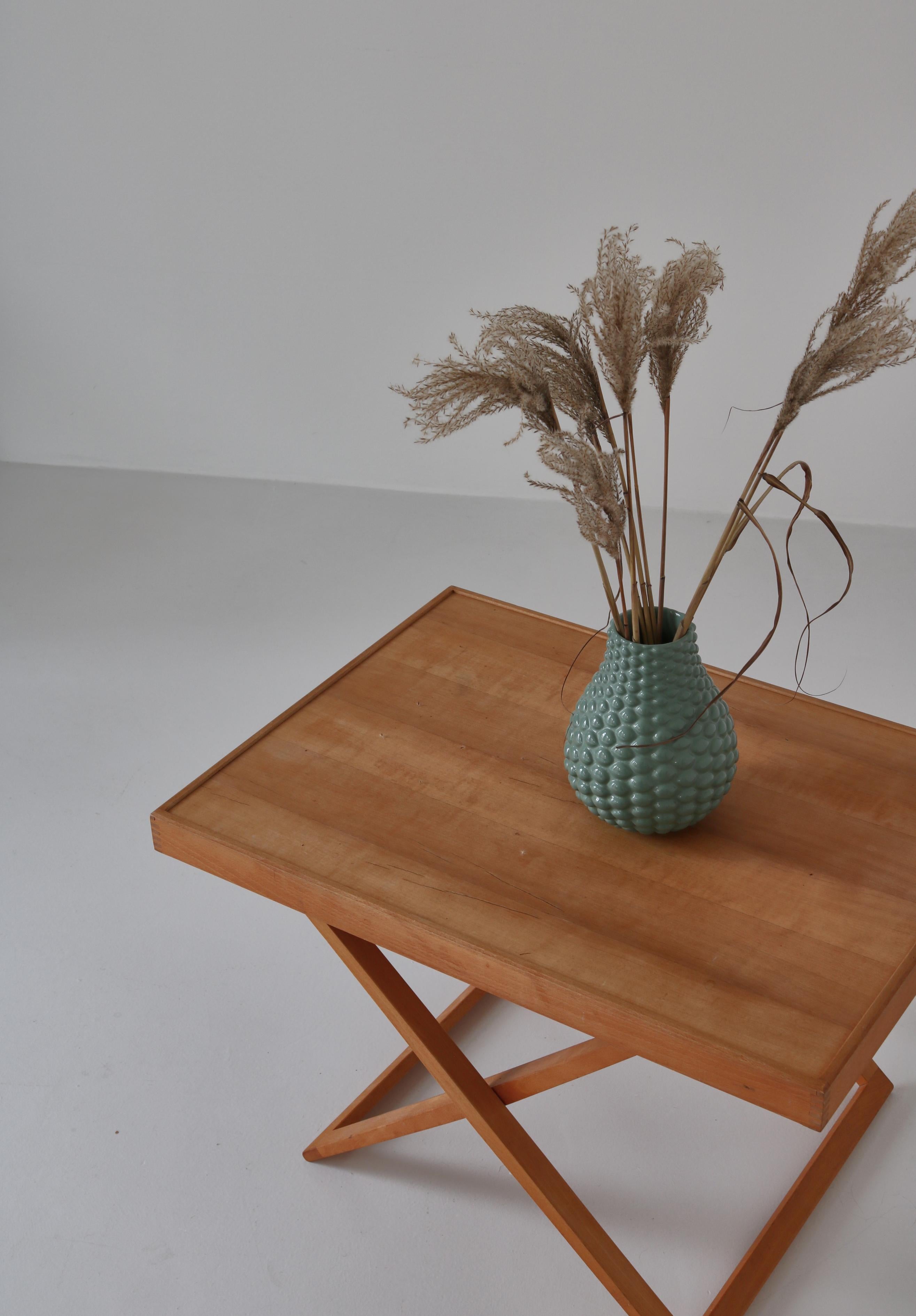 Early example of Mogens Koch´s iconic folding table made at cabinetmaker Rud Rasmussen in the 1960s. The table is made from patinated beechwood and is marked by maker.
The folding table was designed in 1960 as part of a series of folding furniture
