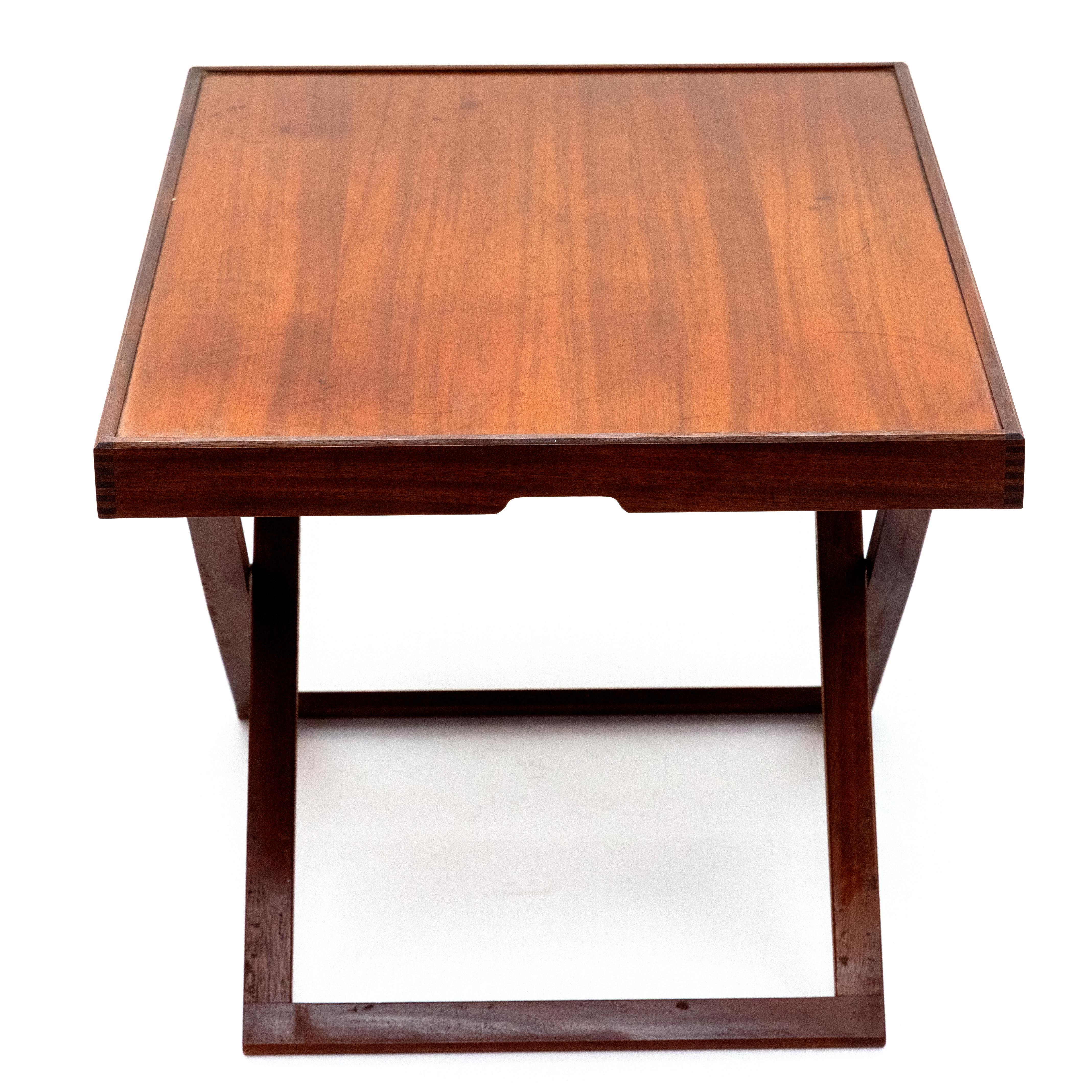An elegant folding tray sofa table in a practical and timeless design, crafted from mahogany.

The table can be easily folded and stowed away, making it ideal for flexible use in any space. It includes the original leather strap for hanging on the