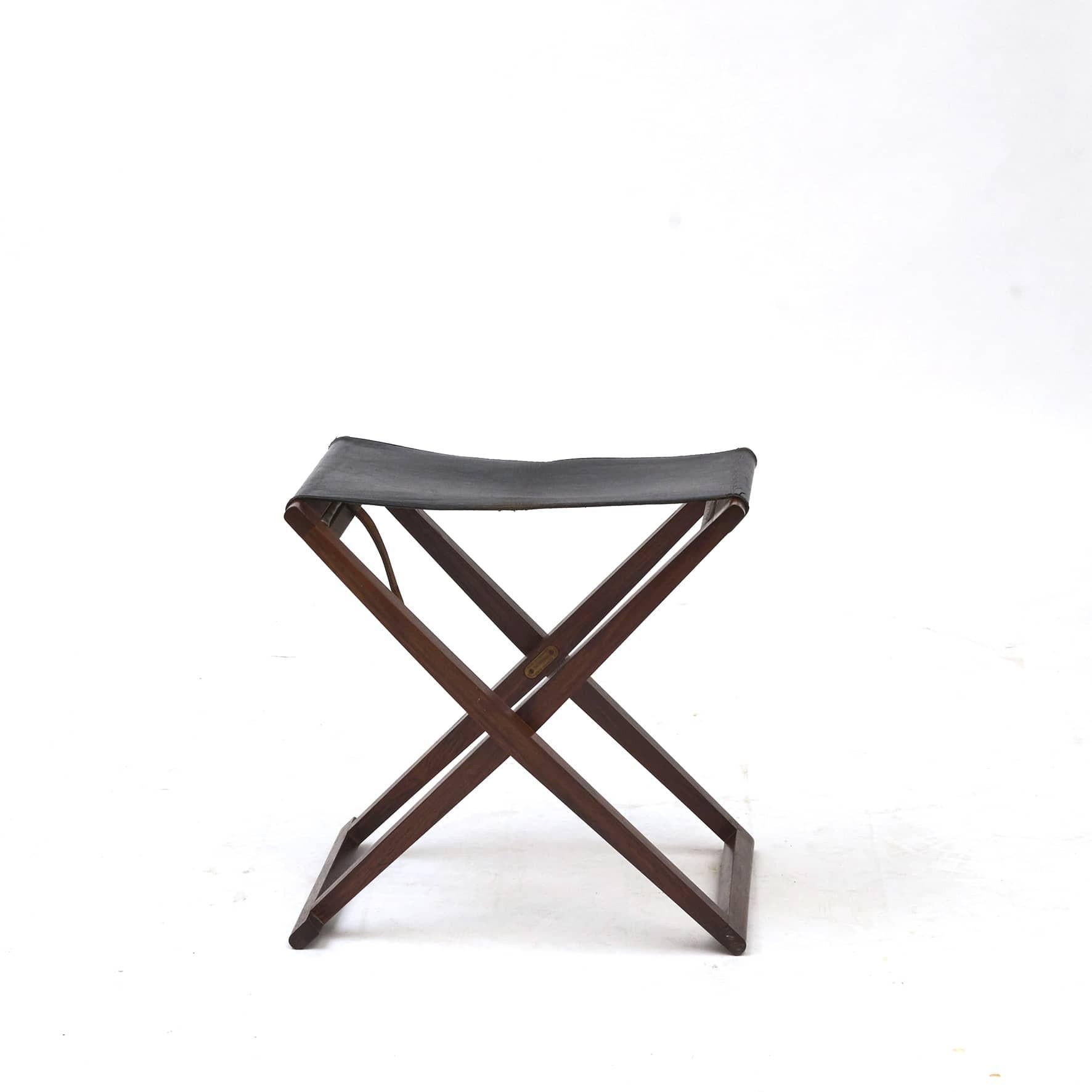 Mogens Koch 1898-1992.
A foldable stool, model No. MK-30, by Danish architect and designer Mogens Koch.
Made of Palisander frame with black leather seating.

Manufactured by Interna, Denmark 1960's.
In untouched and original good condition.