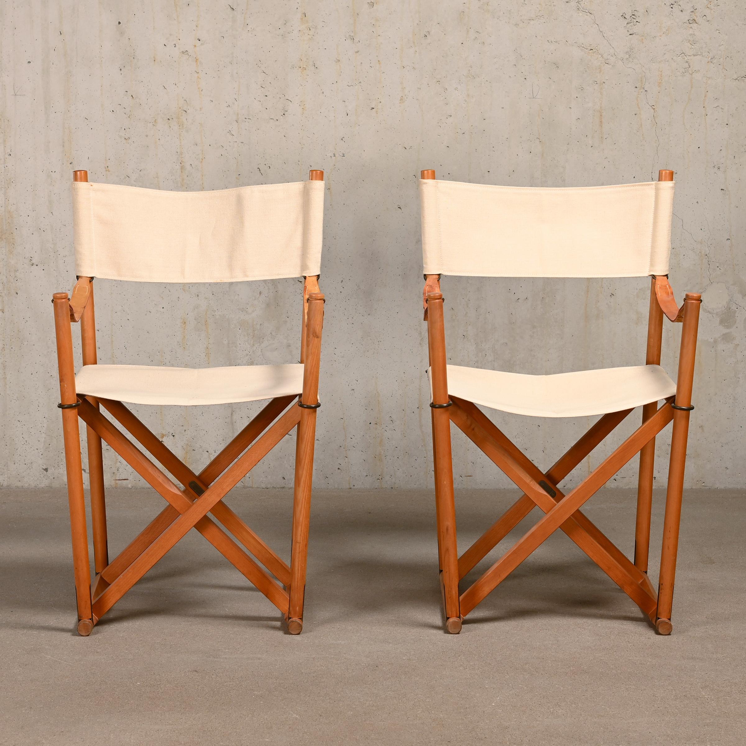 Beautiful made Folding Chairs (model MK16) designed by Mogens Koch in the early thirties. These examples are manufactured by Rud Rasmussen and features a beech wood frame with brass fittings and canvas upholstery with full-grain leather straps.