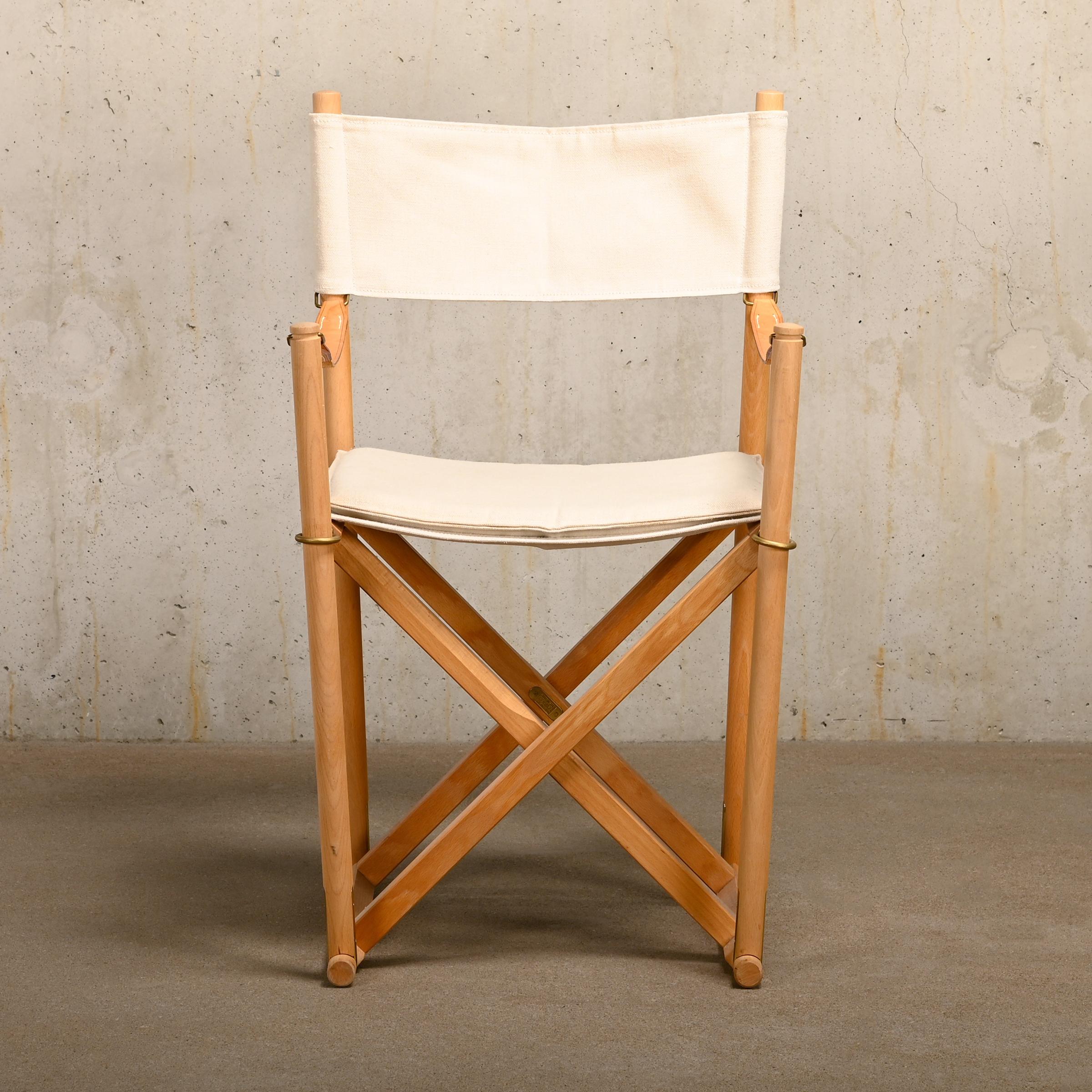 Beautiful made Folding Chairs (model MK16) designed by Mogens Koch in the early thirties. This example is manufactured by Rud Rasmussen and features a beech wood frame with brass fittings and canvas upholstery and canvas cushion with full-grain