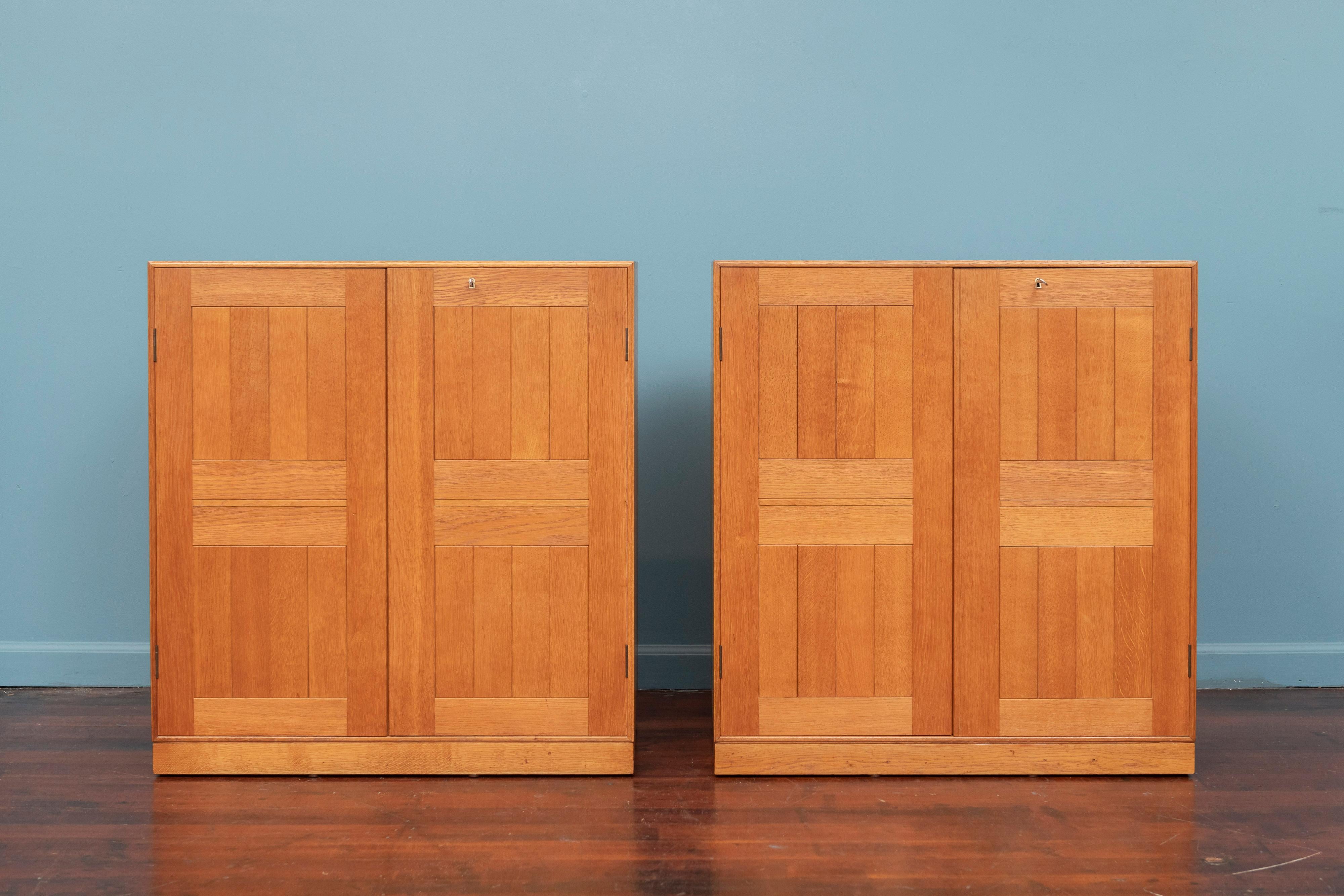 Mogens Koch solid oak cabinets or nightstands for Red. Rasmussen, Denmark. High quality construction and materials newly refinished and ready to install. Perfect pair of cabinets flanking a fireplace, doorway or as nightstands. Adjustable shelves