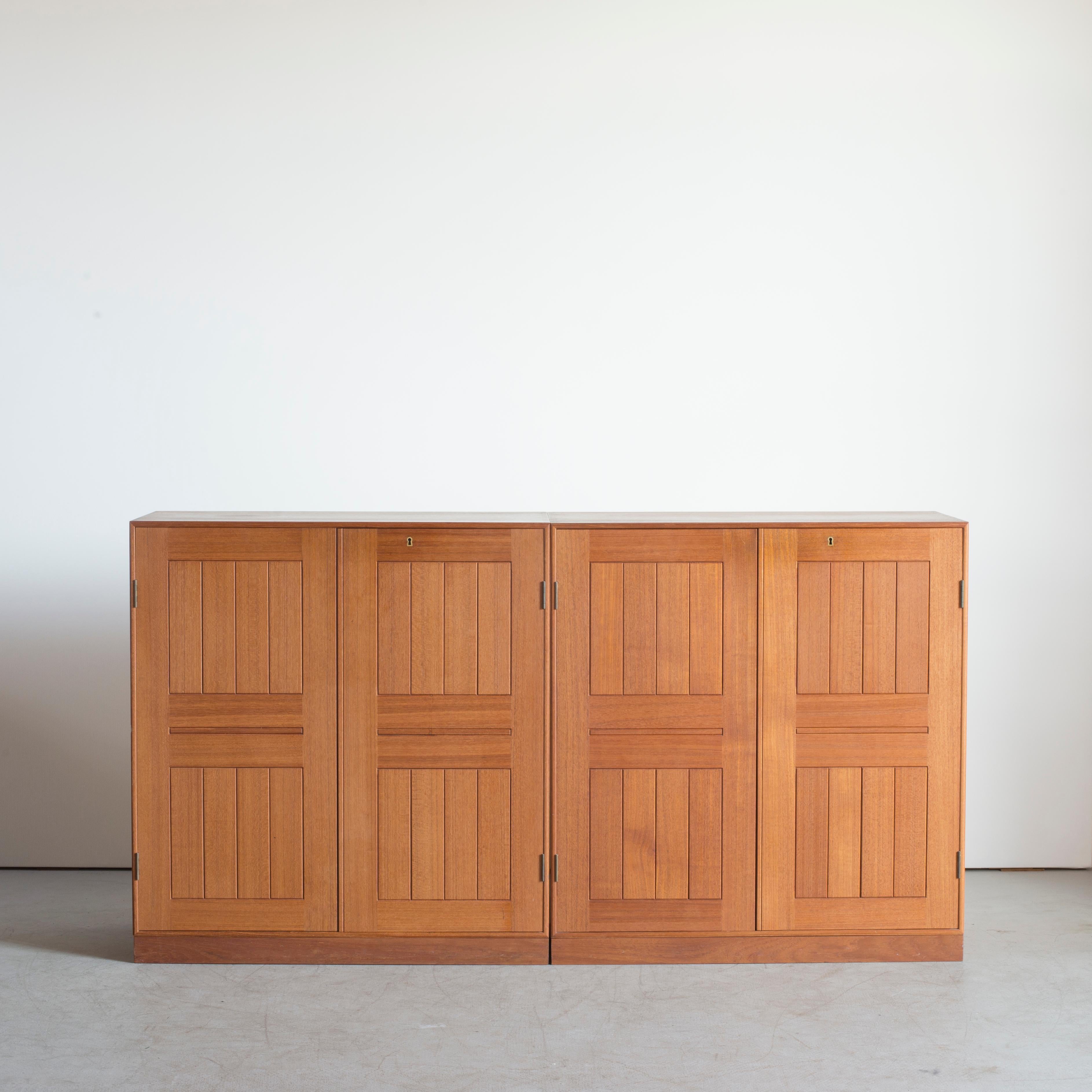 Mogens Koch cabinets in Teak with bases, inside drawers of Maple. Executed by Rud. Rasmussen.

Reverse with paper labels ‘RUD. RASMUSSENS/SNEDKERIER/KØBENHAVN/DENMARK
