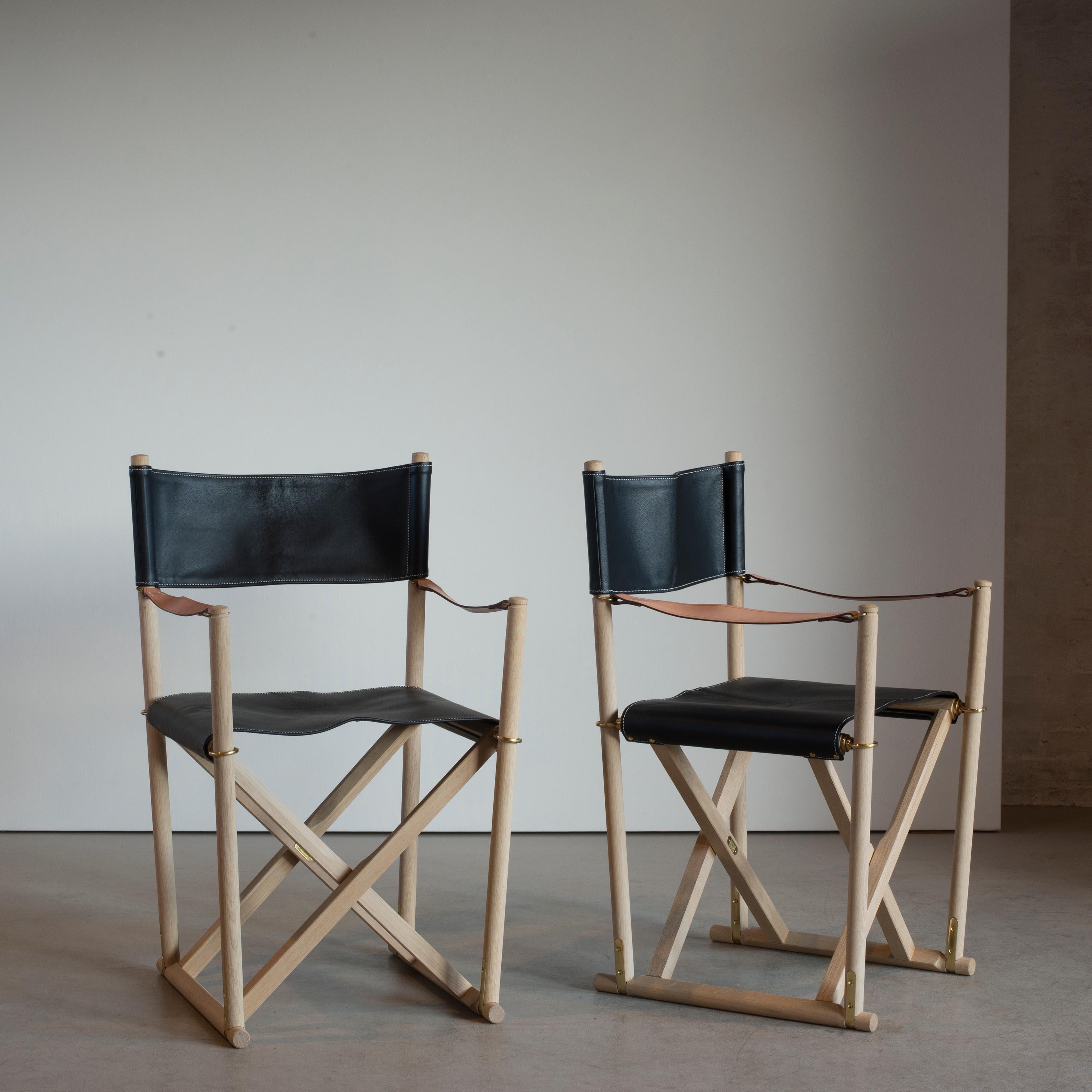 Mogens Koch pair of folding chairs in oak and leather. Executed by Rud. Rasmussen, Copenhagen, Denmark.