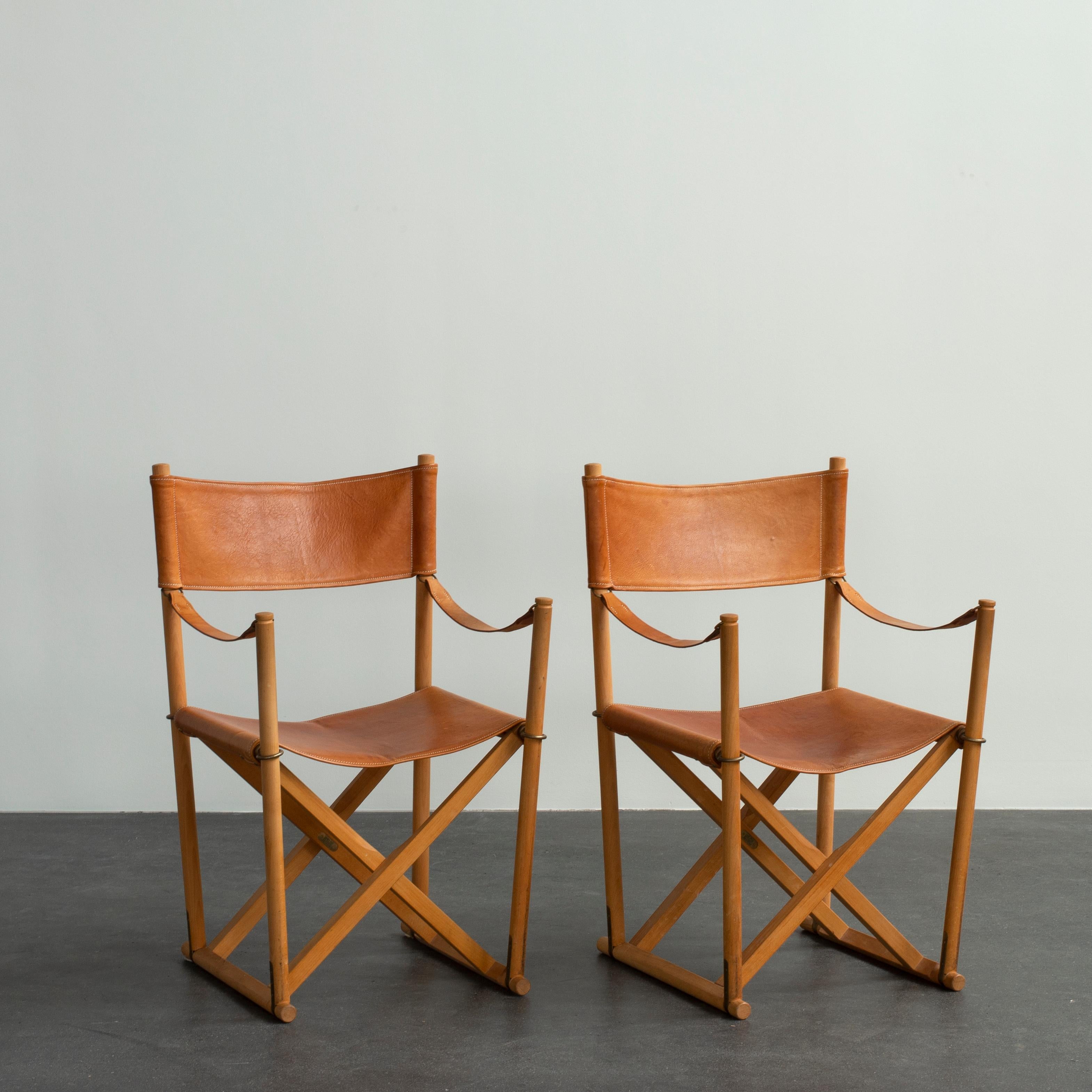 Mogens Koch pair of folding chairs in beech and vegetable-tanned leather. Executed by Rud. Rasmussen, Copenhagen, Denmark.