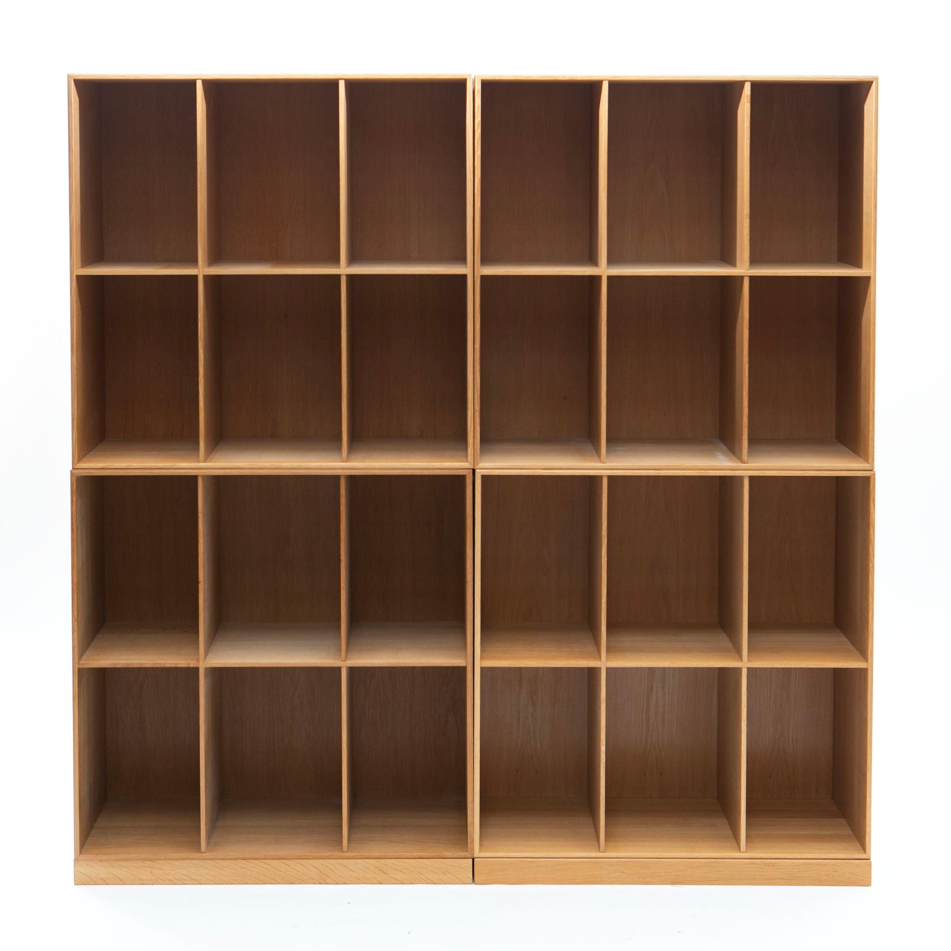 Set of 4 bookcases crafted in solid oak with accompanying bases, produced by renowned Danish cabinetmakers Rud Rasmussen (with original label).

This special edition was created in 2007 to celebrate the 75th anniversary of the original 1932
