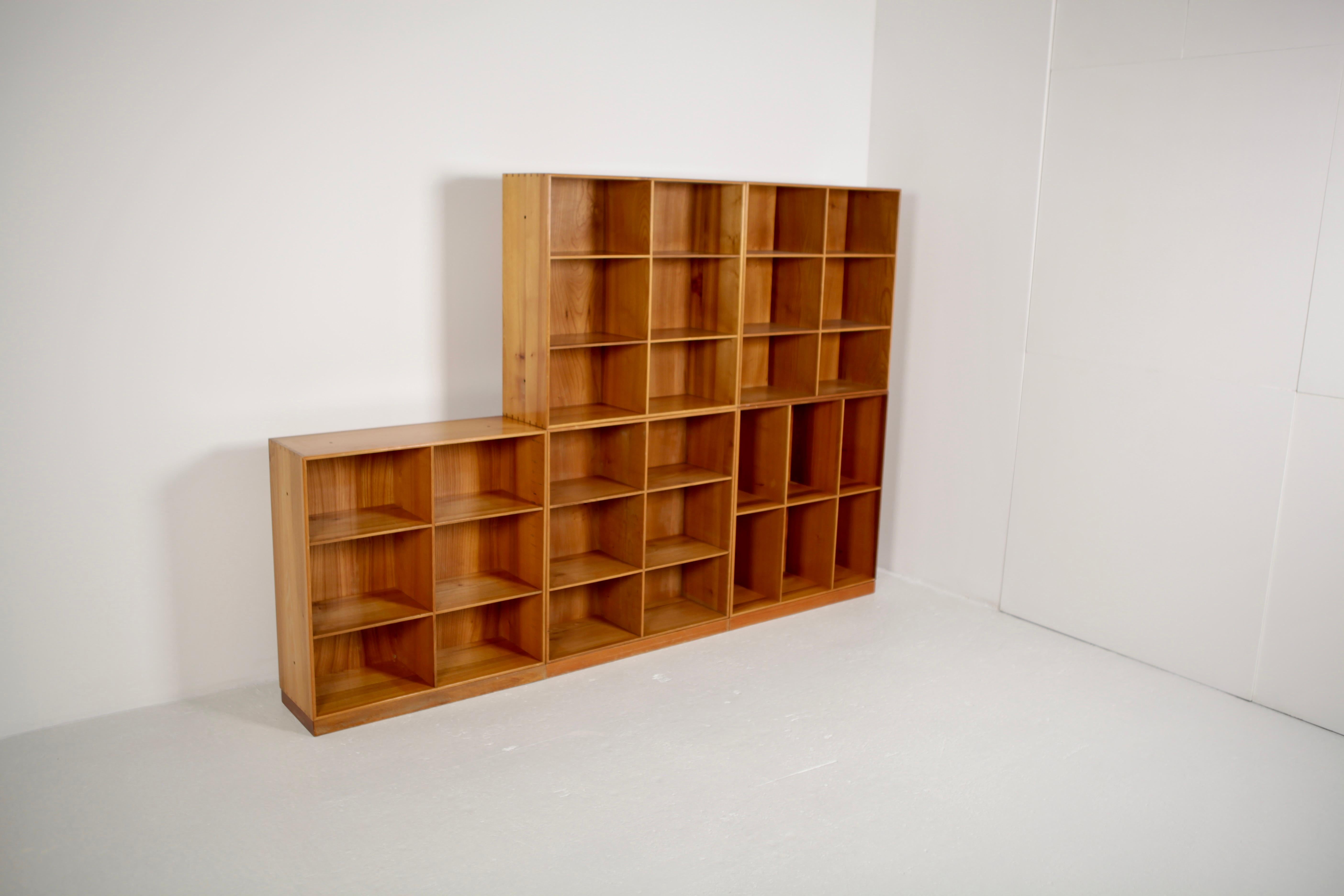 A set of 5 elm bookcases designed by Mogens Koch and manufactured by Rud. Rasmussen cabinetmakers in 1933, in Copenhagen.
Signed with paper label to the reverse.
 