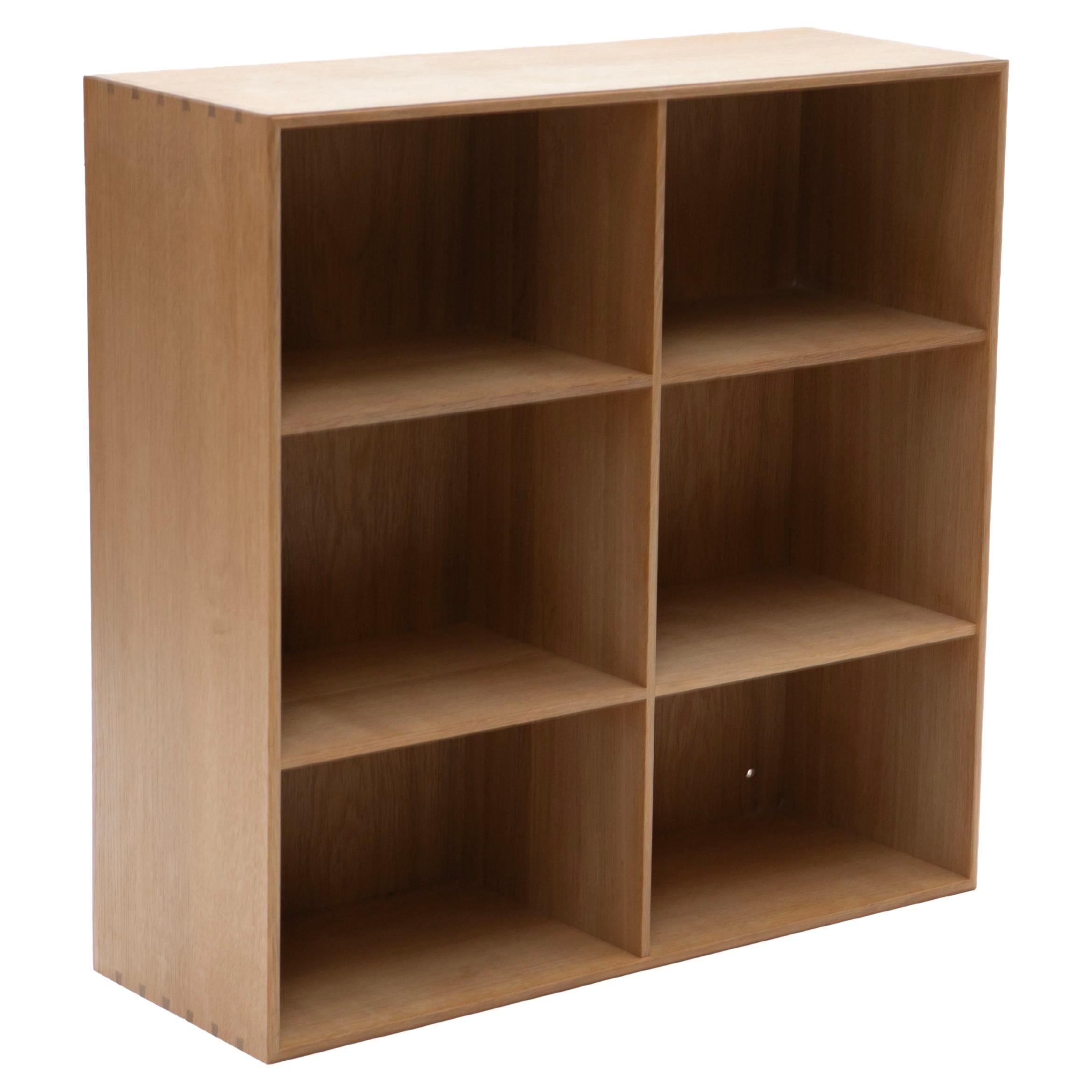 Mogens Koch (Danish, b. Frederiksberg 1898, d. Copenhagen 1992)
Bookcase in solid oak, crafted by one of Denmark's most renowned furniture designers.
Known for his timeless designs, this bookcase features six compartments and can be positioned