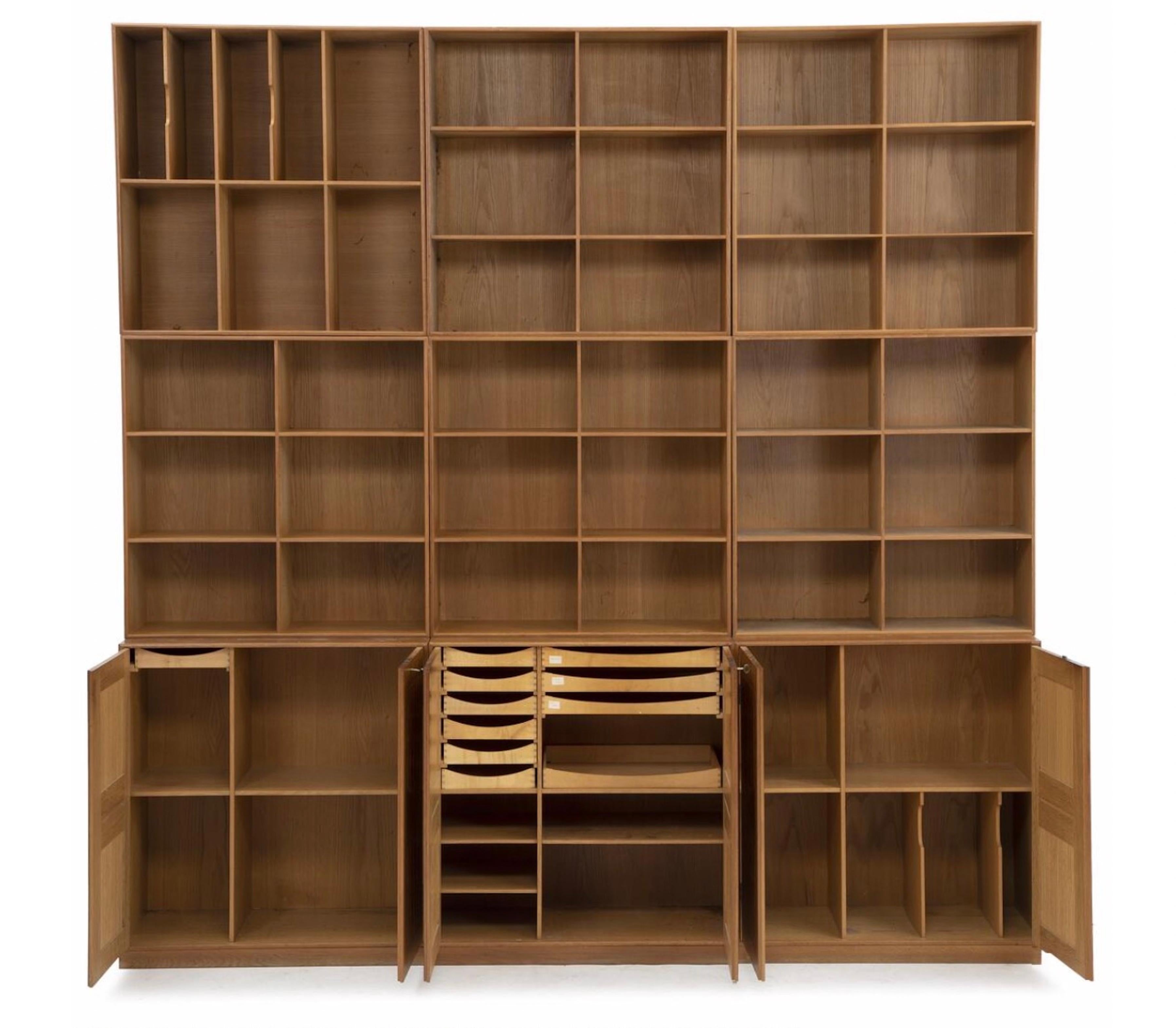 Mogens koch wall unit of solid walnut.Consisting of three cabinets ,six bookcases and three plinths..Brass fittingsEleven pullout trays.Made and marked by Rud Rasmussen.Two keys included.Very good condition.