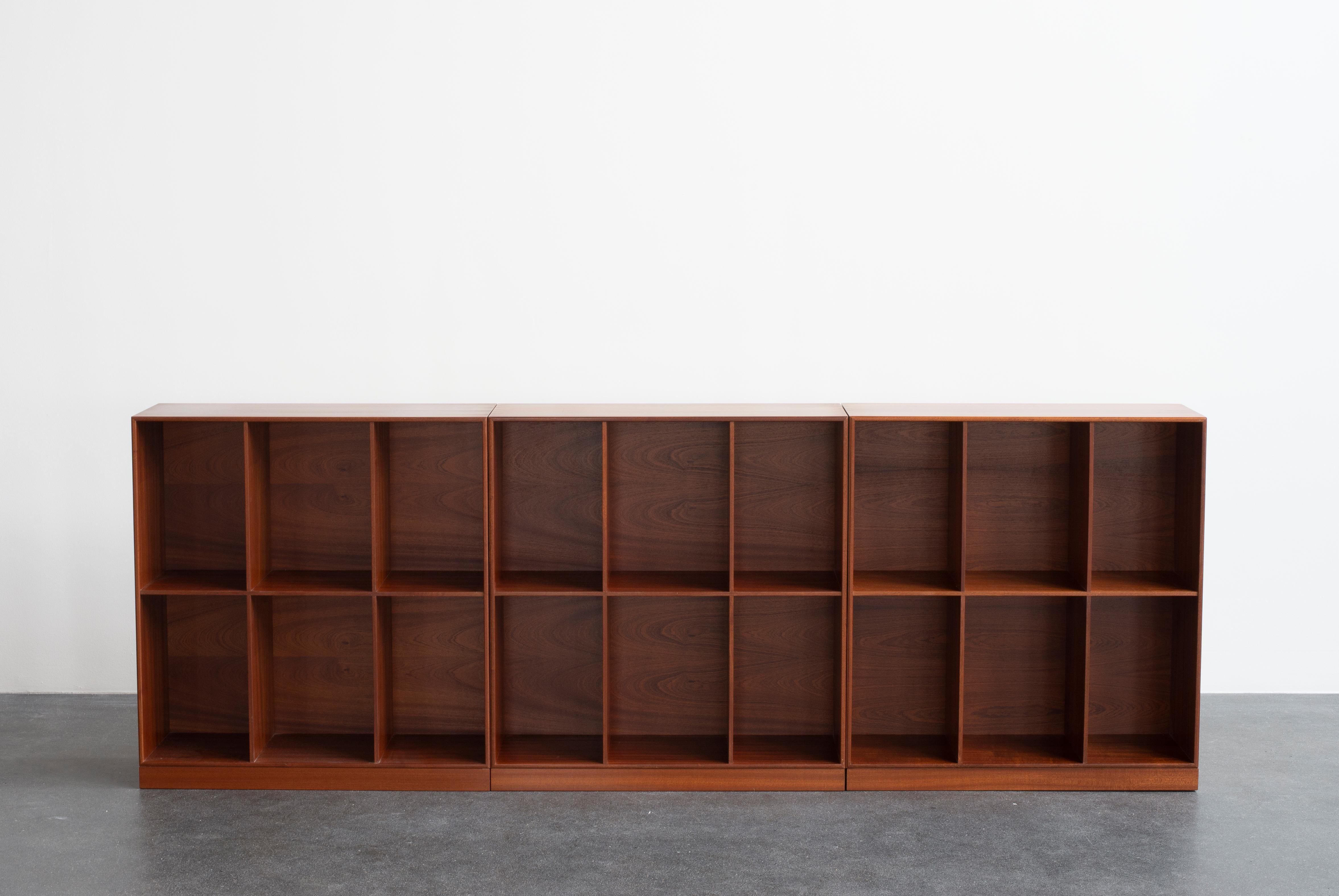 Mogens Koch three bookcases in mahogany + plinths. Executed by Rud. Rasmussen.

The reverse with paper labels ‘RUD. RASMUSSENS/SNEDKERIER/COPENHAGEN/DENMARK.