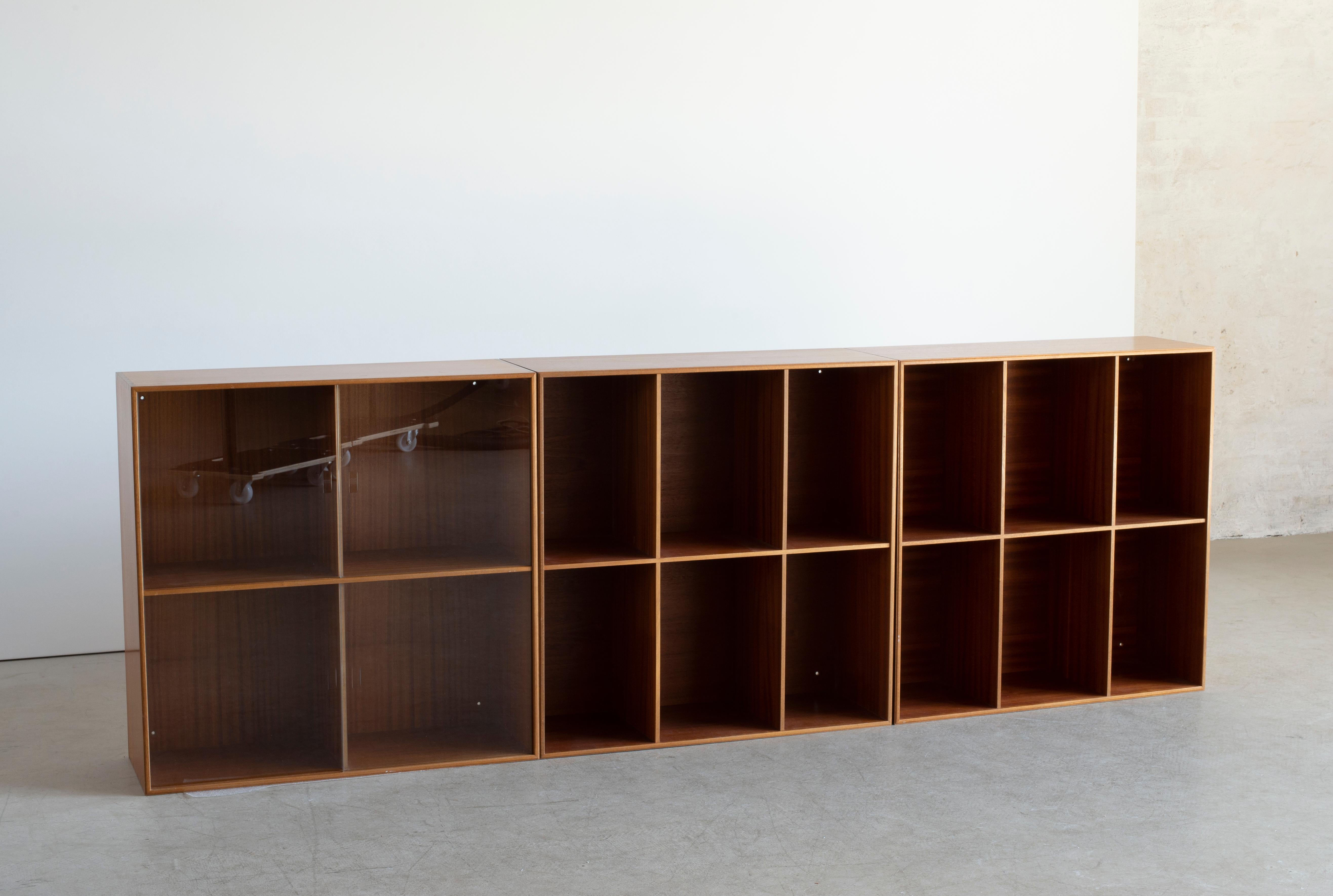 Mogens Koch three bookcases in mahogany. Executed by Rud. Rasmussen.

The reverse with paper labels ‘RUD. RASMUSSENS/SNEDKERIER/COPENHAGEN/DENMARK.


