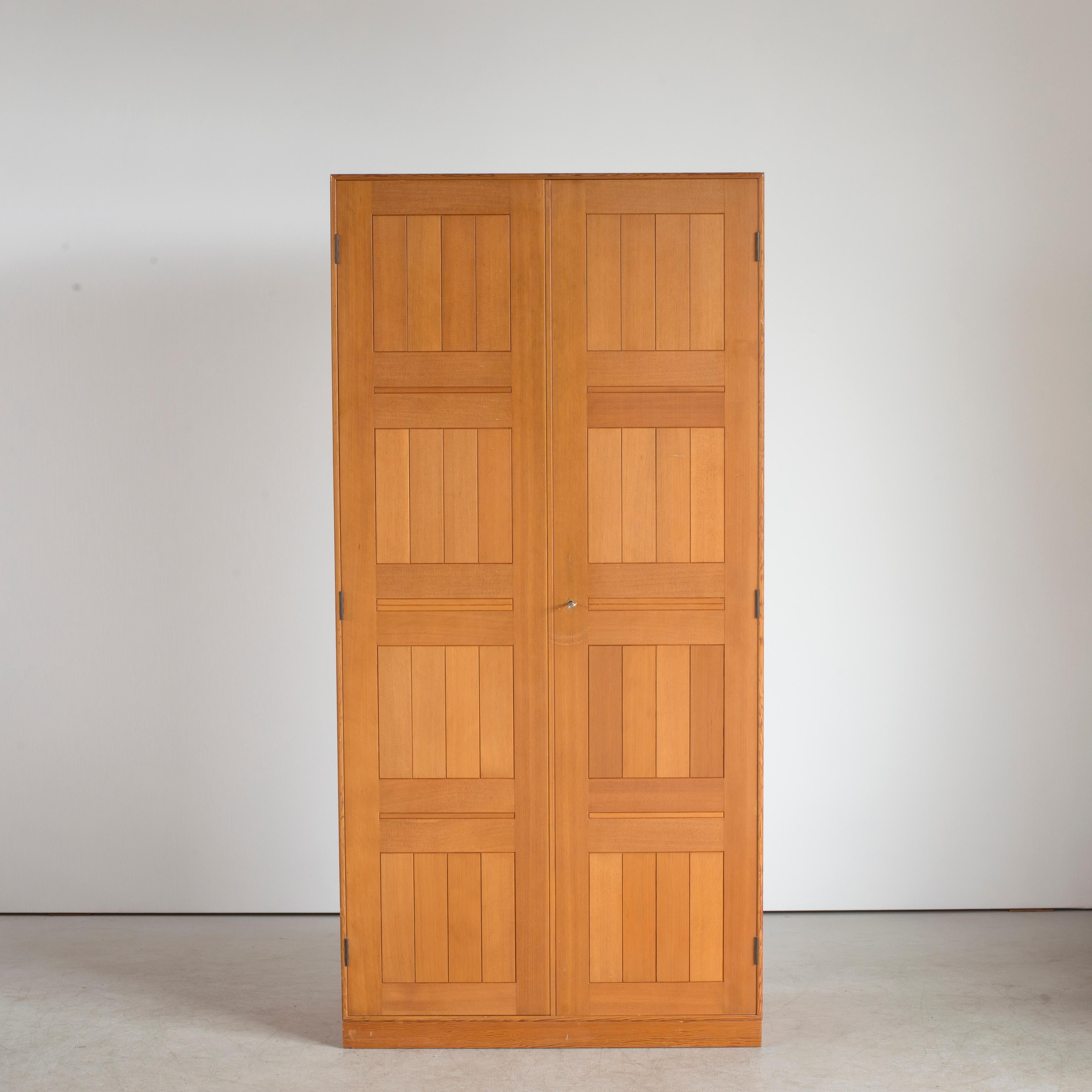 Wardrobe of Oregon pine with matching plinth. Made and marked by Rud. Rasmussen cabinetmakers, Copenhagen.