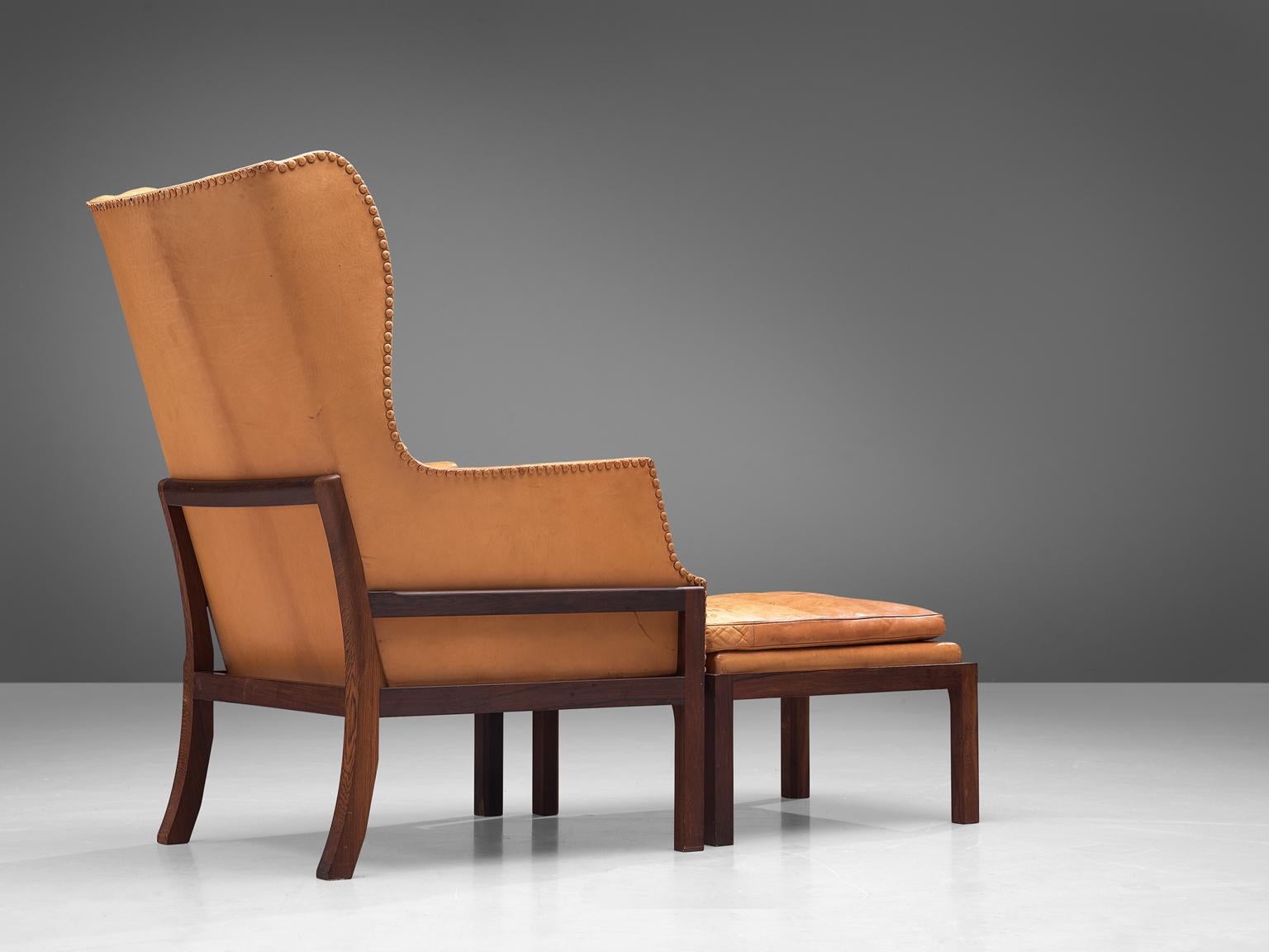 Mid-Century Modern Mogens Koch Wingback Chair and Ottoman in Dark Mahogany, Cognac Leather