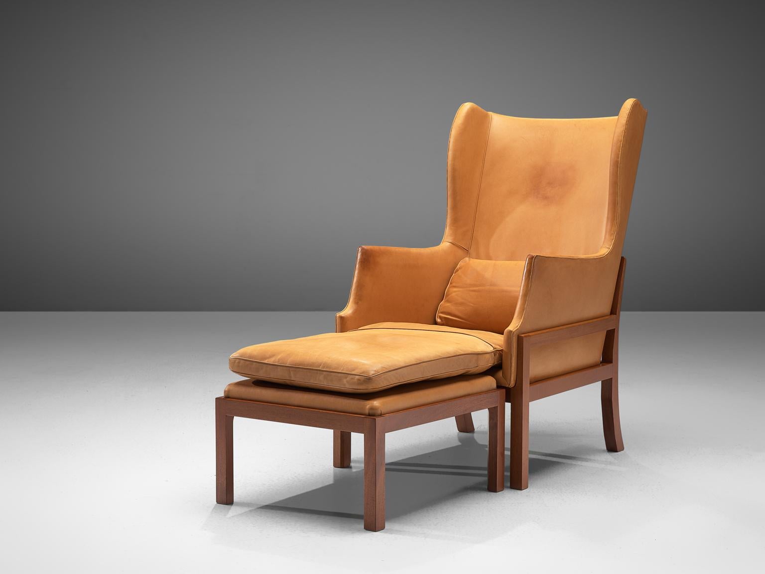 Mogens Koch for Rud Rasmussen, wingback chair and ottoman model MK50, mahogany and leather, Denmark, 1936.

Elegant and comfortable armchair in mahogany and light cognac leather by Mogens Koch. This lounge chair was designed with high attention to