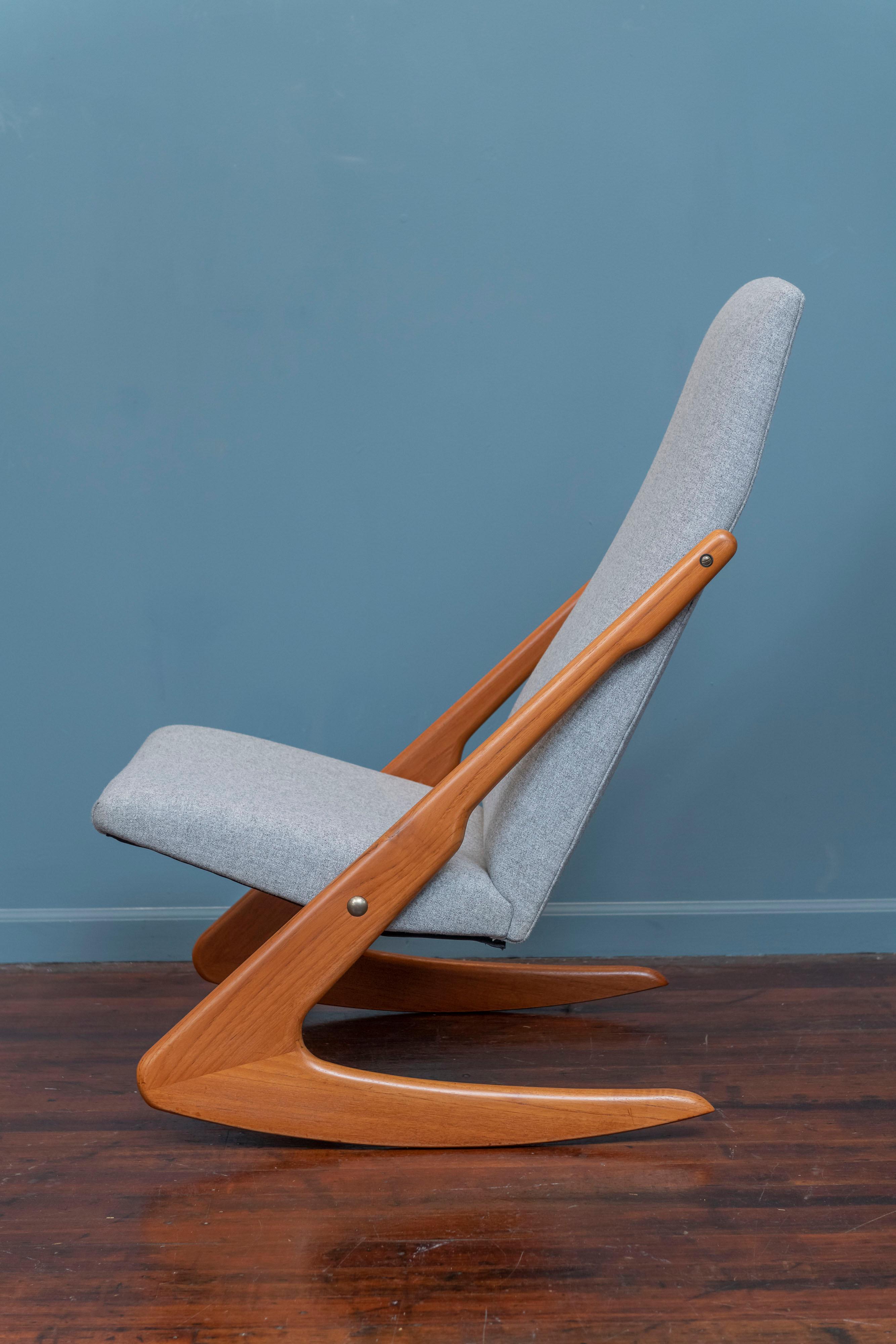 Mogens Kold design teak rocking chair, Denmark. Newly refinished and upholstered in a light grey wool, ready to rock!
