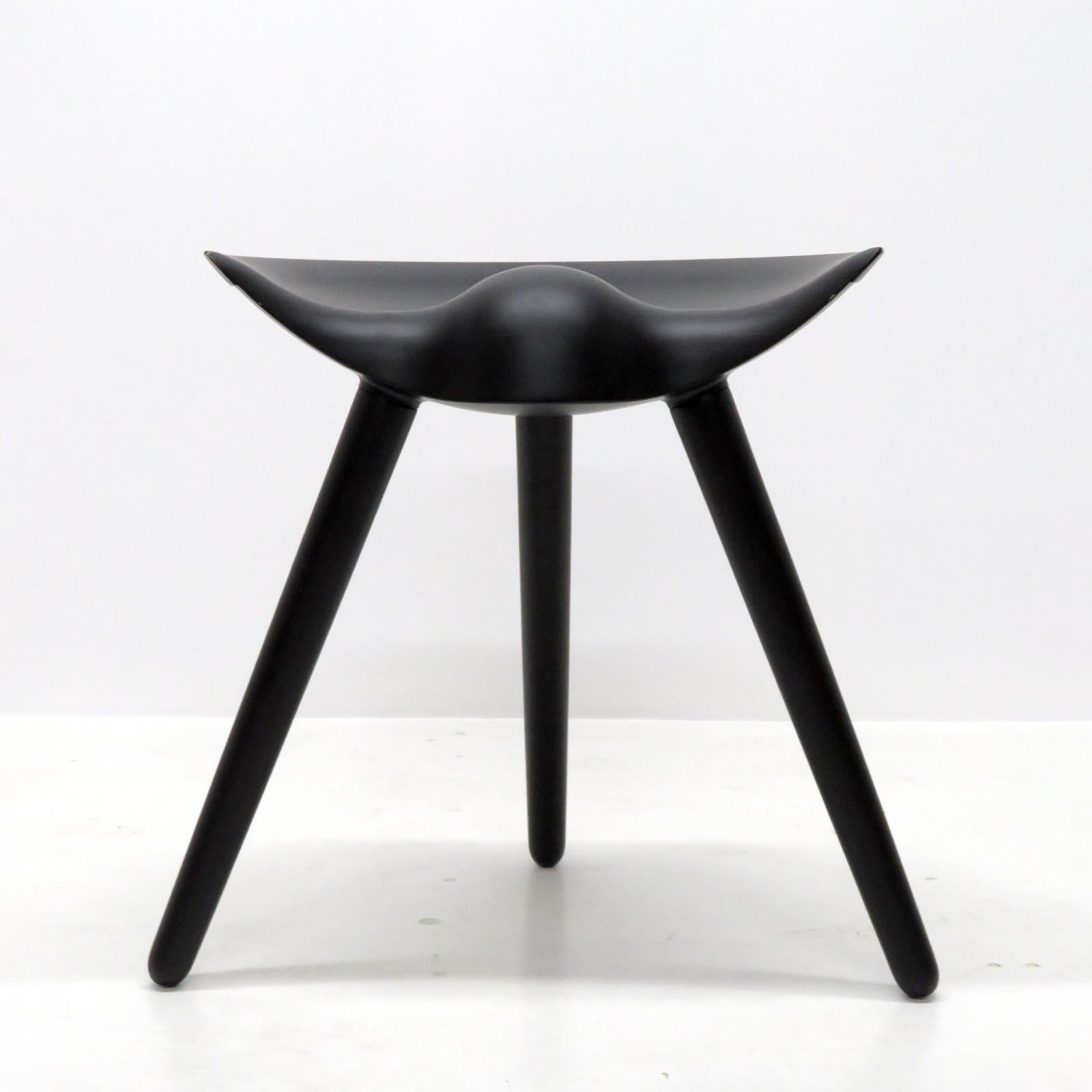 Wonderful stool by Mogens Lassen, in solid, black-stained beech wood with a semi-circular seat on three tapered, round legs, manufactured and branded 'By Lassen, Copenhagen'. Priced individually.
 